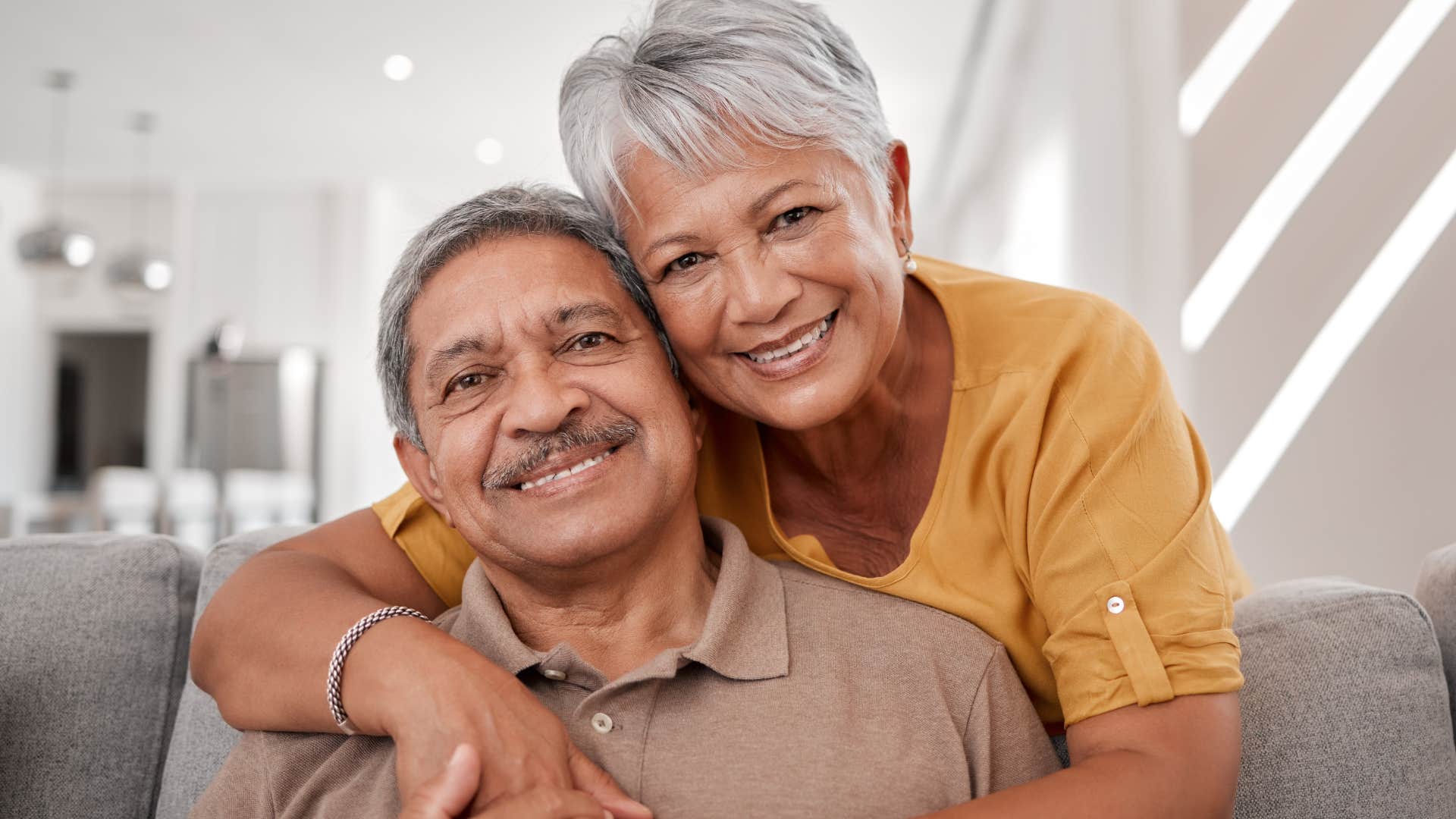 woman trusting her partner and hugging him from behind