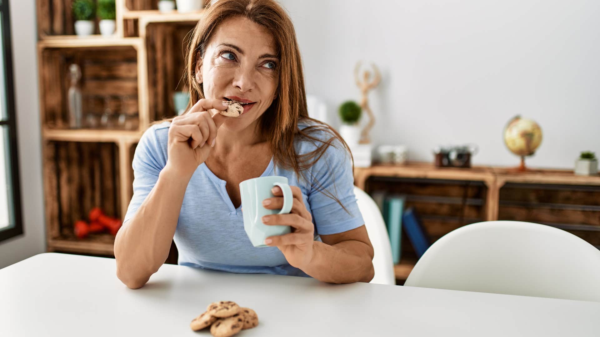 grown woman eating cookies and milk like she did in her youth