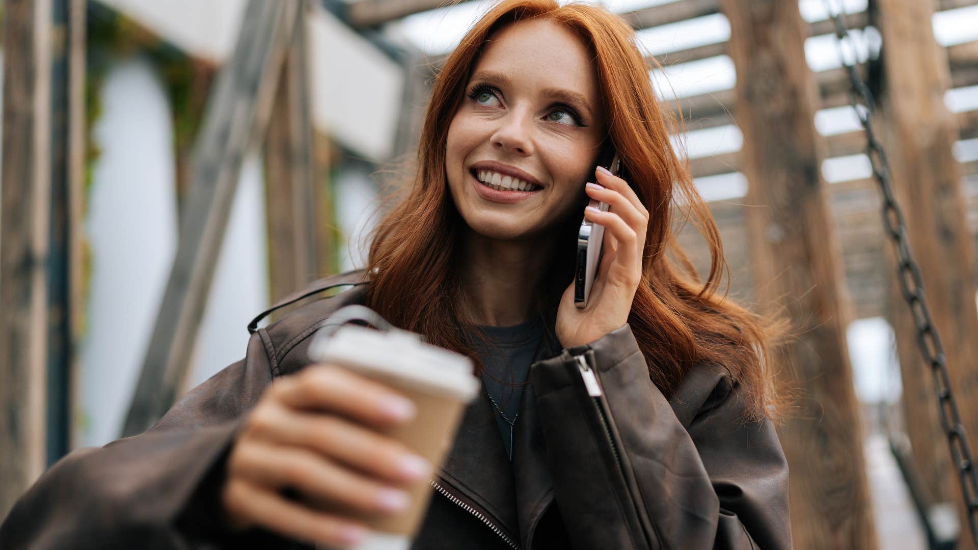 grown woman talking on the phone sitting in a playground