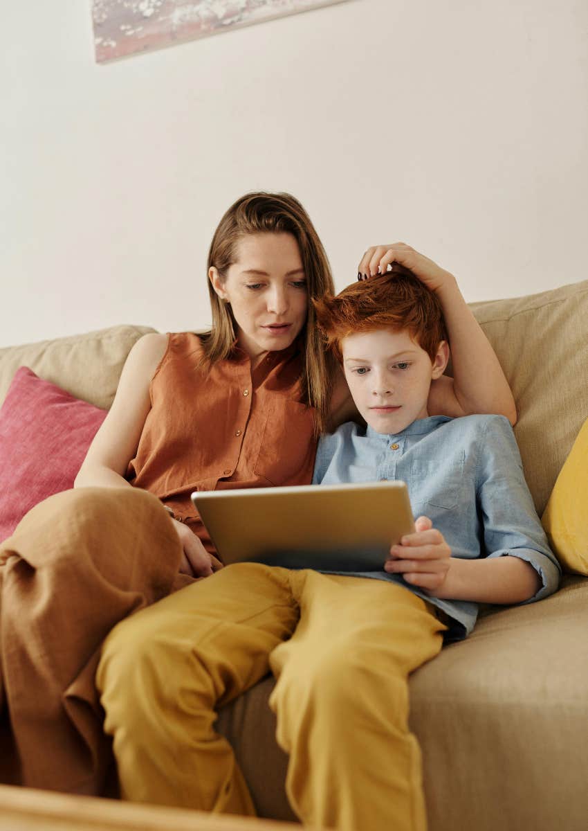 mom looking at tablet with her son
