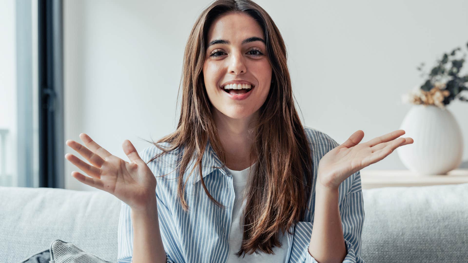people-pleasing woman smiling on her couch