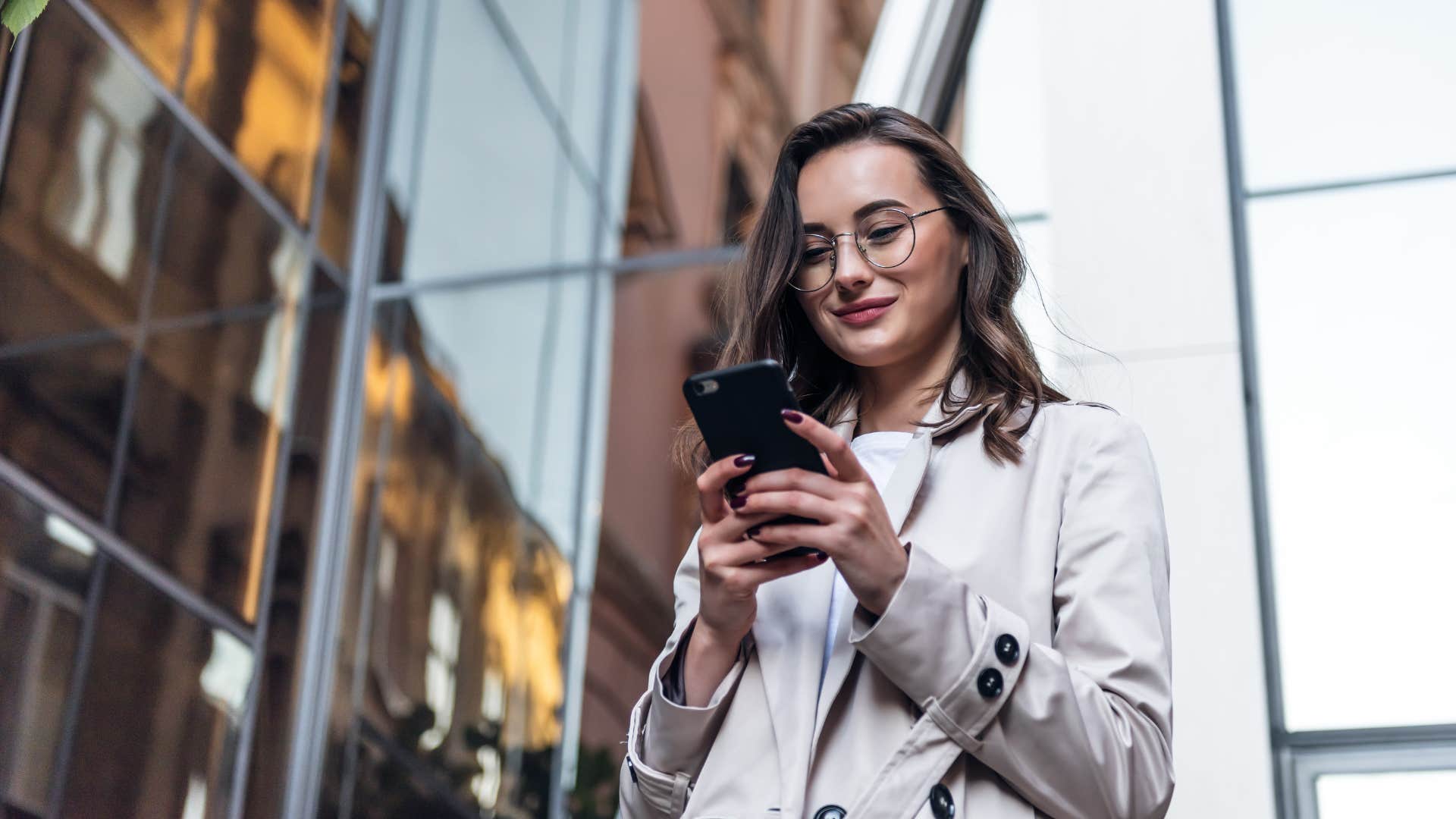 woman unworried about being late looking at her phone