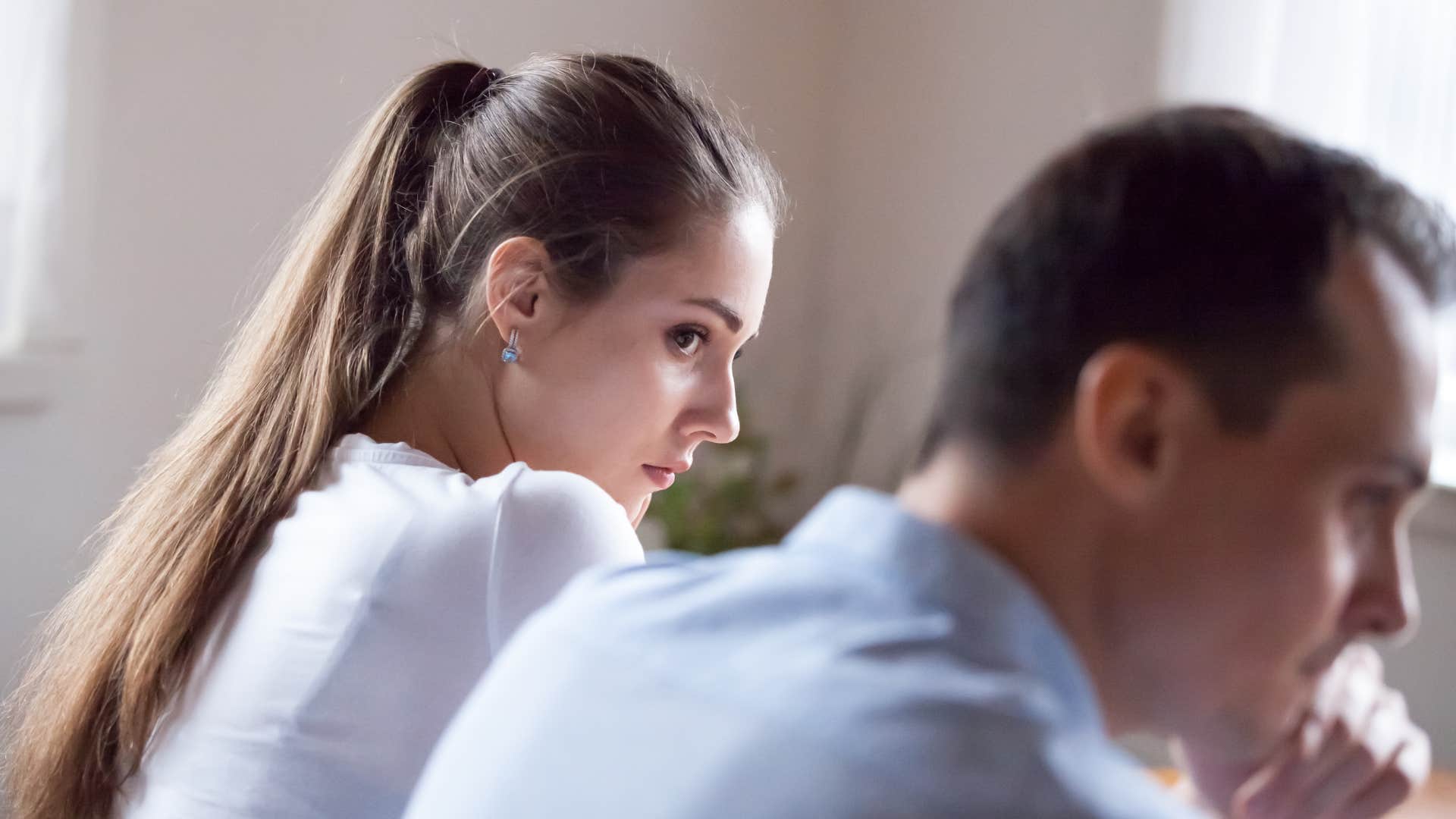 upset woman giving husband side eye holding onto a grudge
