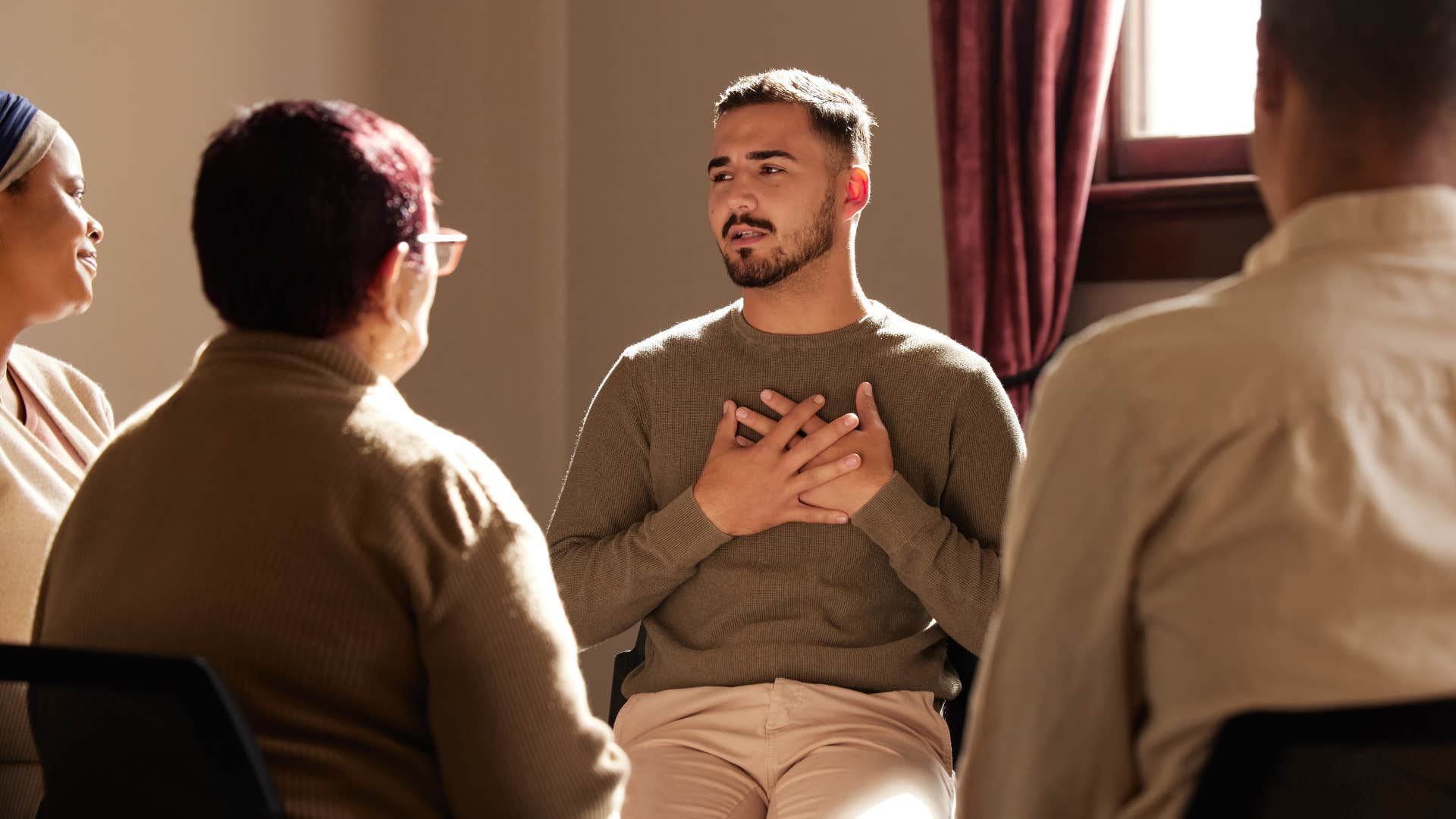 man talking in group therapy taking care of his mental health