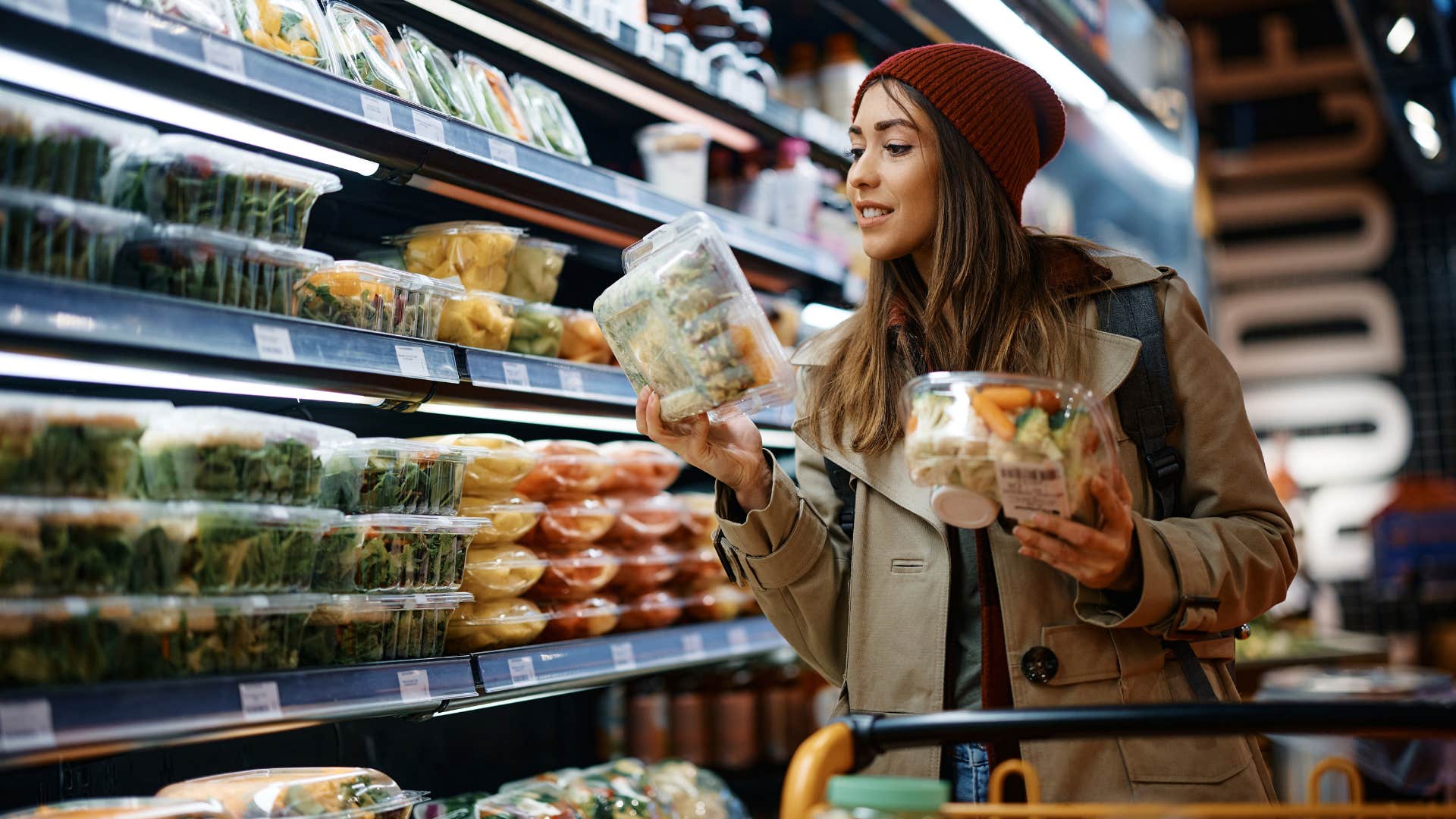 woman looking at price tag of grocery item
