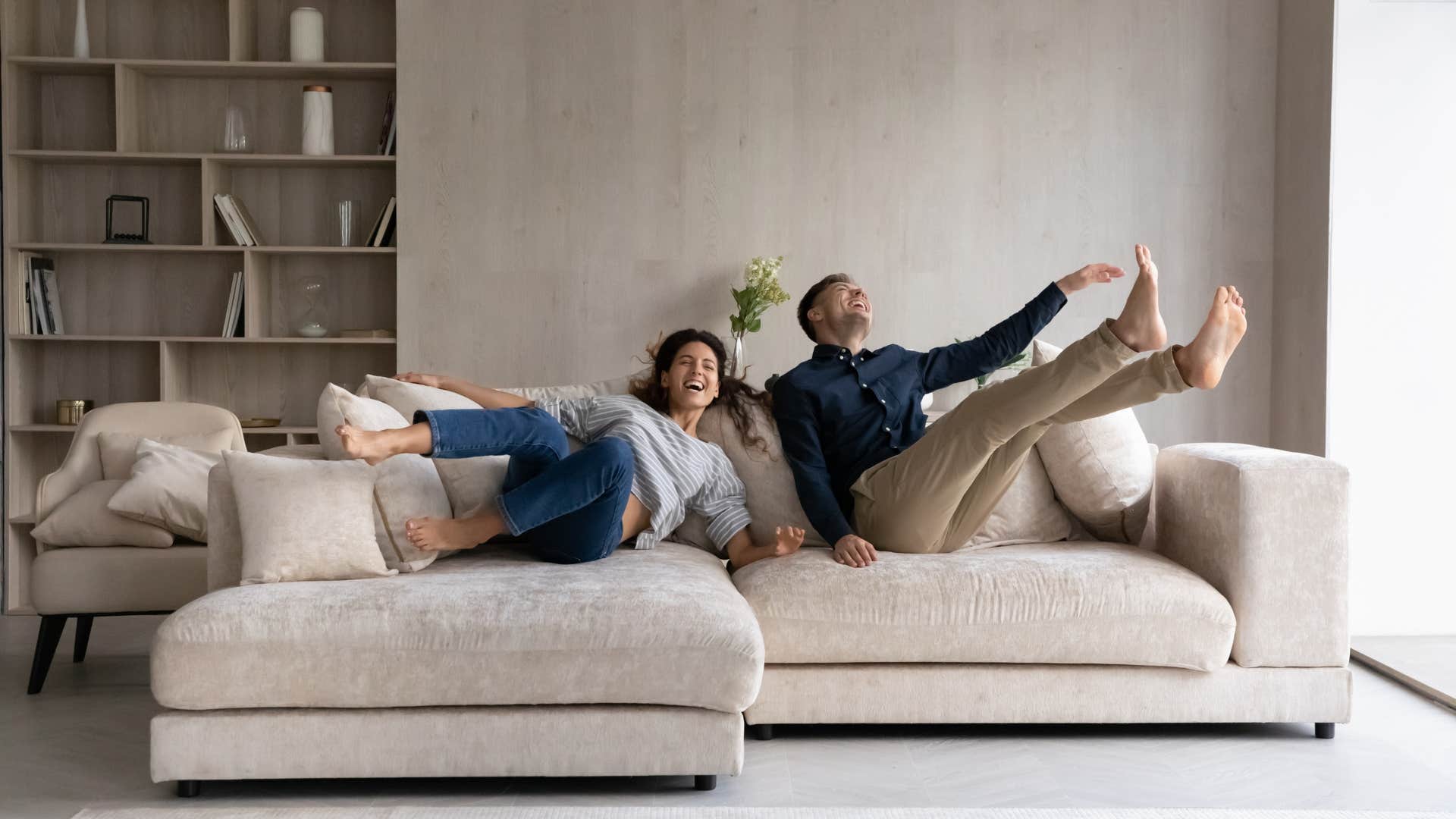 couple laughing on brand new couch
