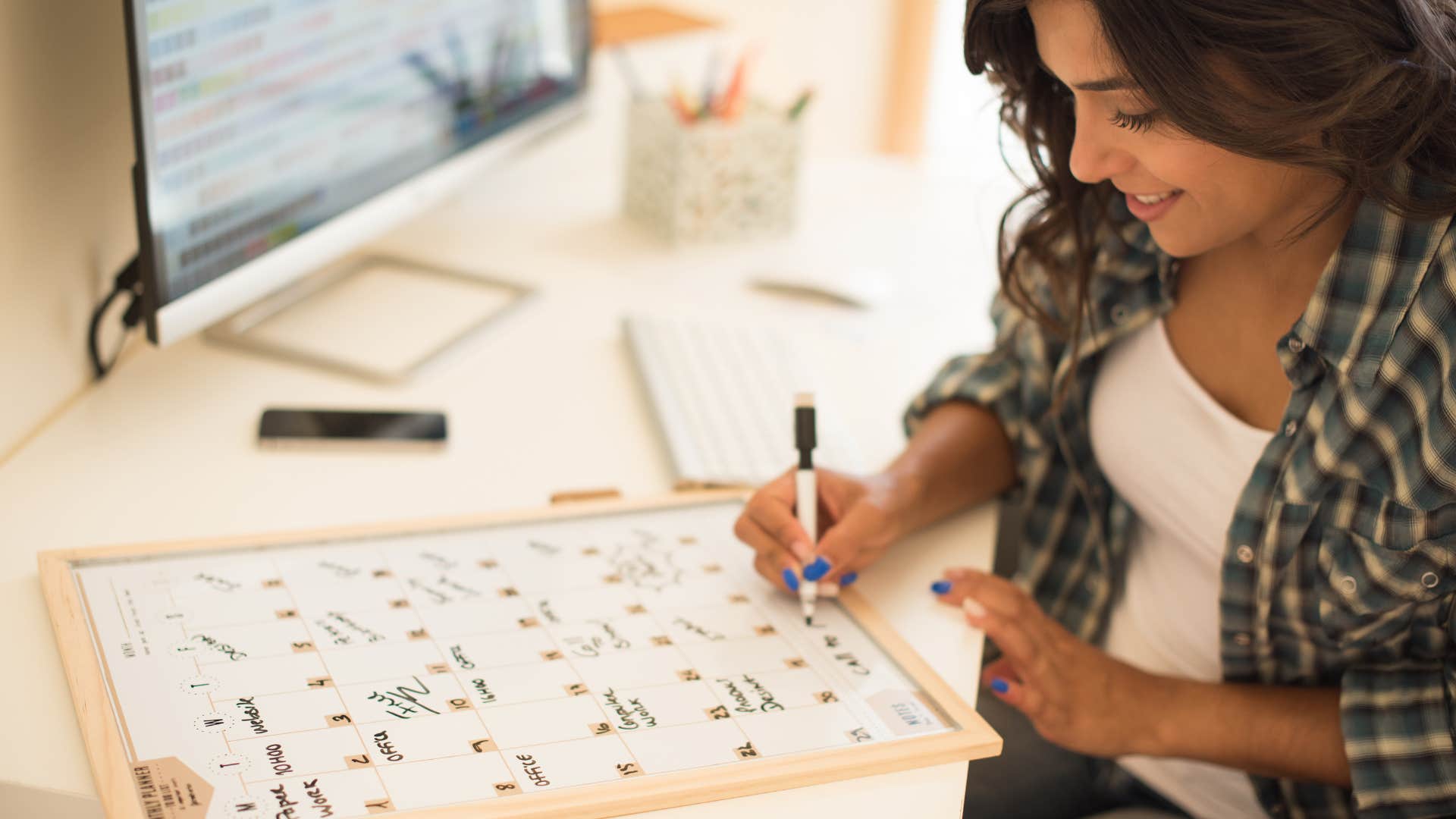 woman writing on calendar