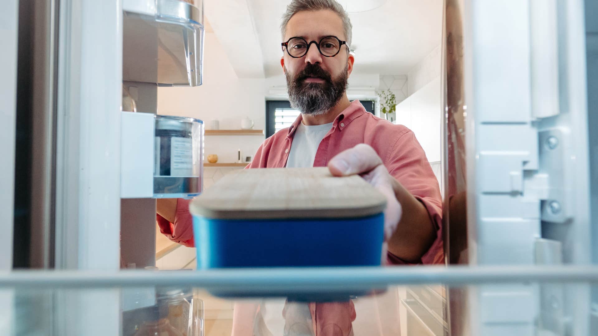 man using a food storage container