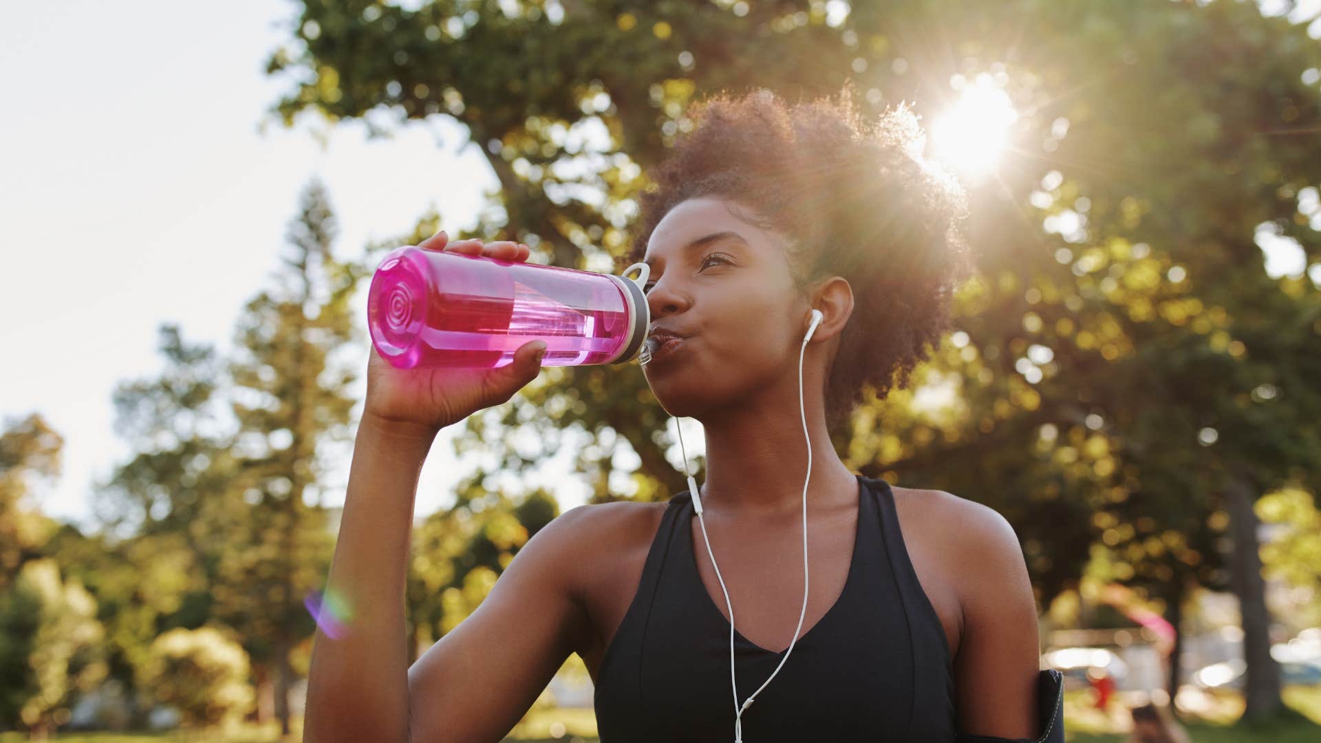 woman using a reusable water bottle