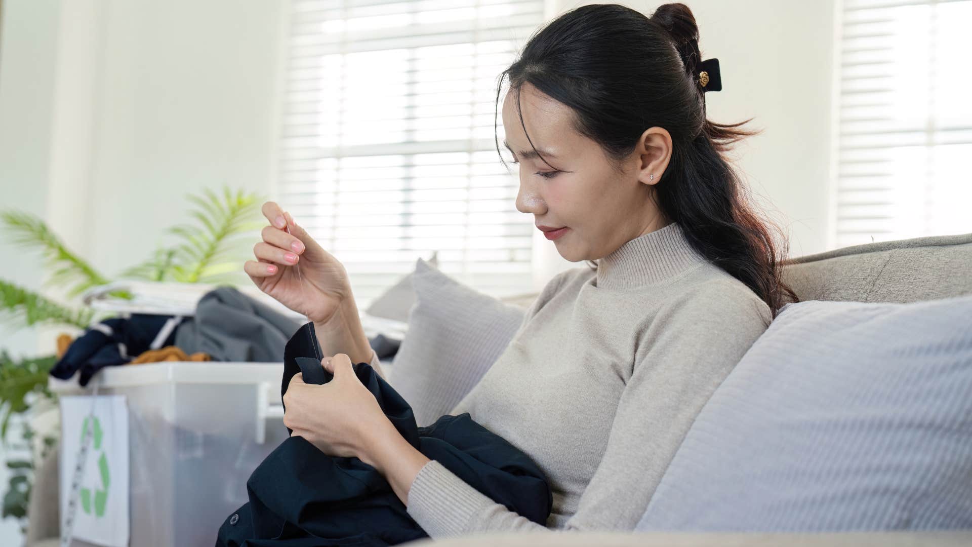 woman using a sewing kit