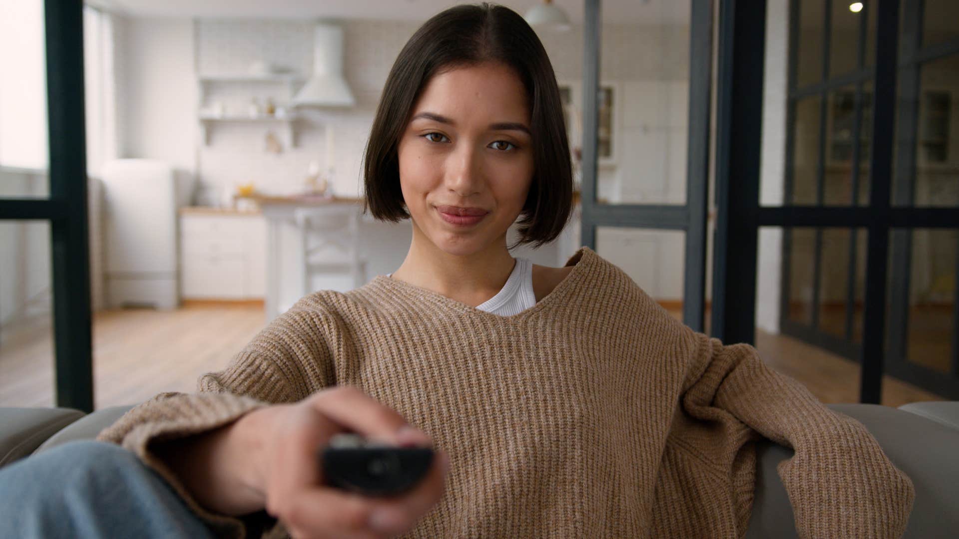woman using a streaming device to watch tv