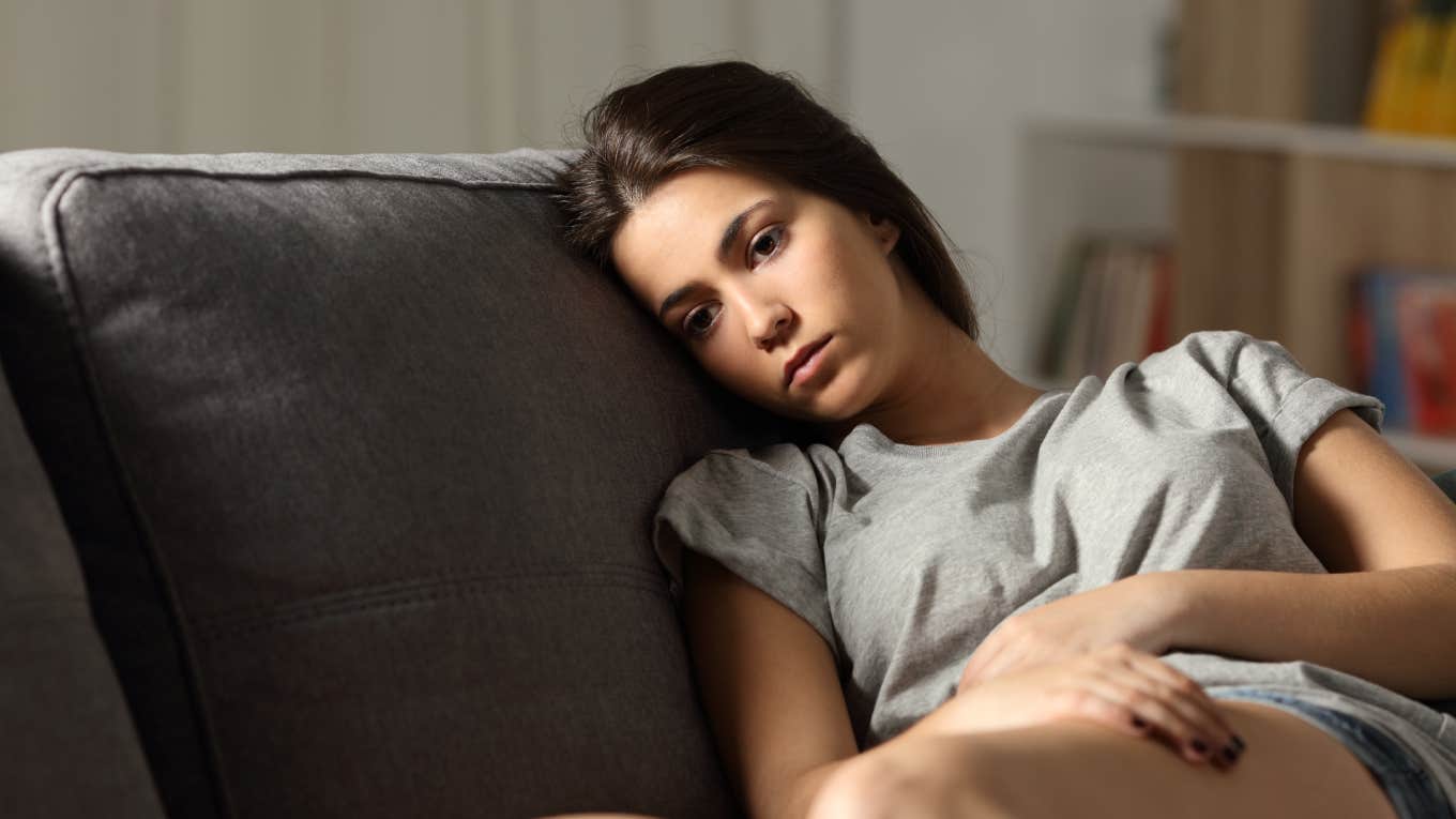 Anxious Adults Are Regressing To Infancy In An Attempt To Feel Less Stressed anxious adult sitting on couch