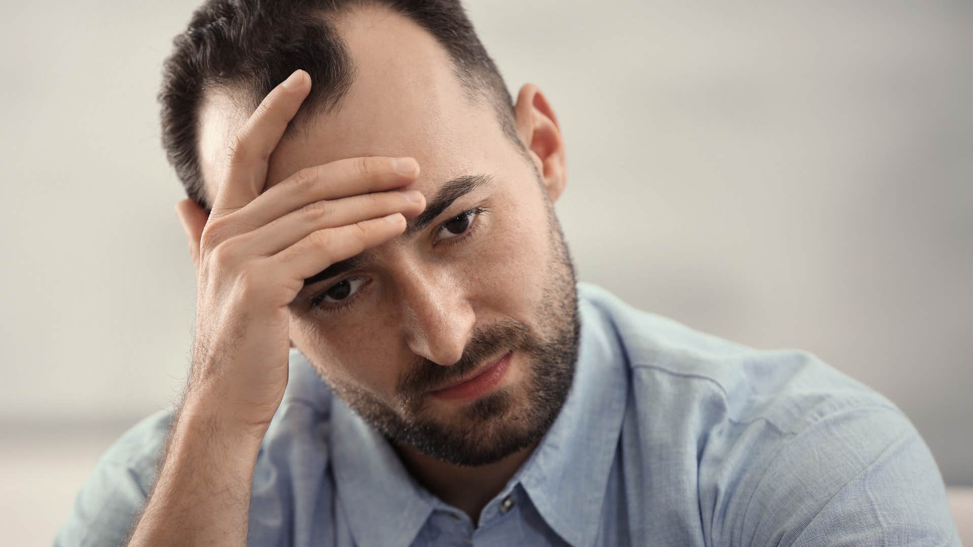 sad man feeling incompetent thanks to narcissistic mother