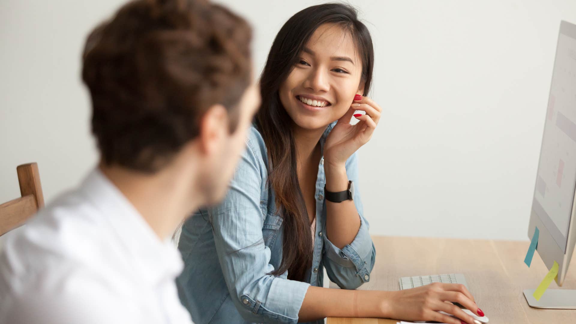Woman saying "I actually did that too" to a man at work.