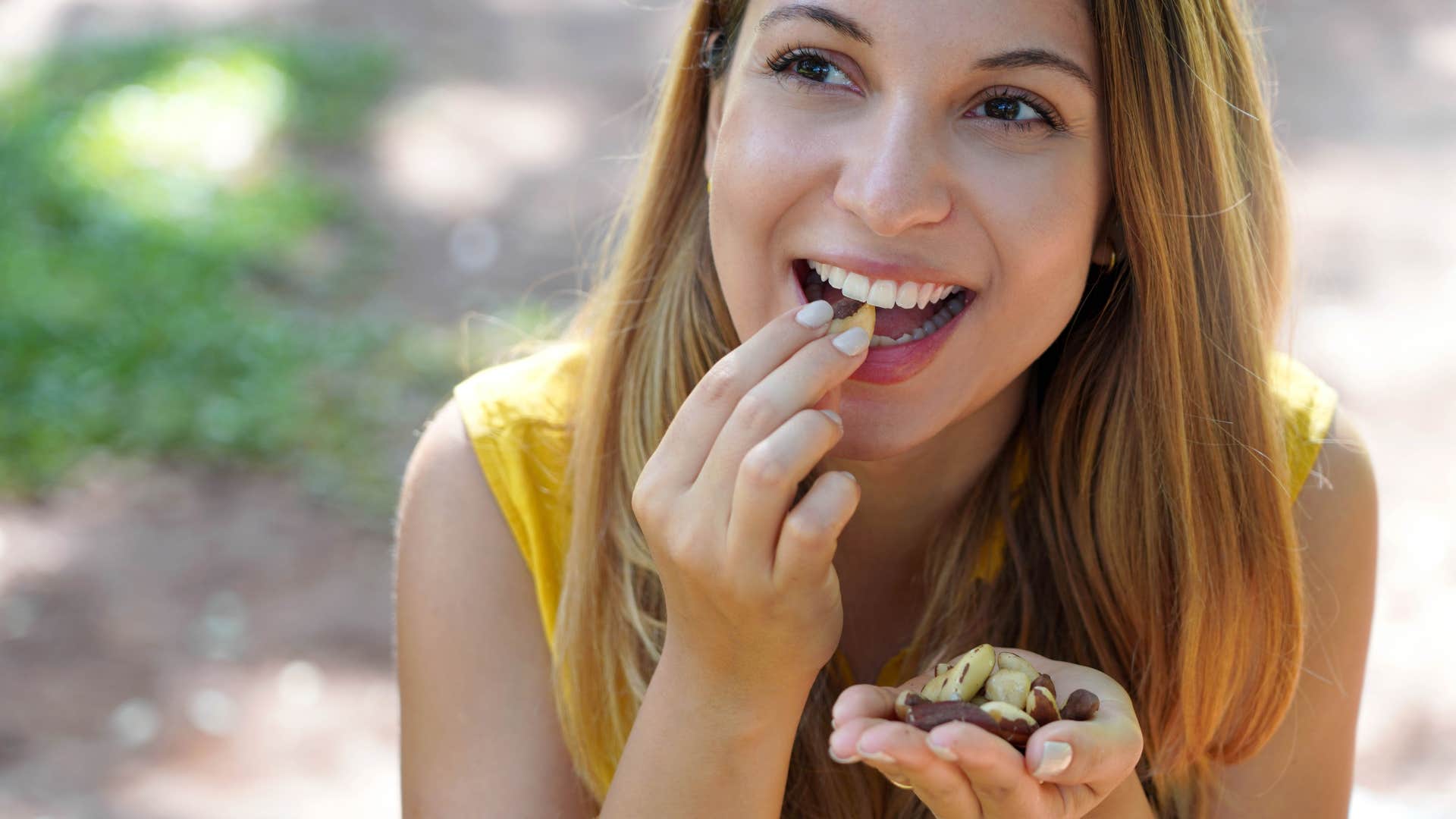 woman eating almonds as snack
