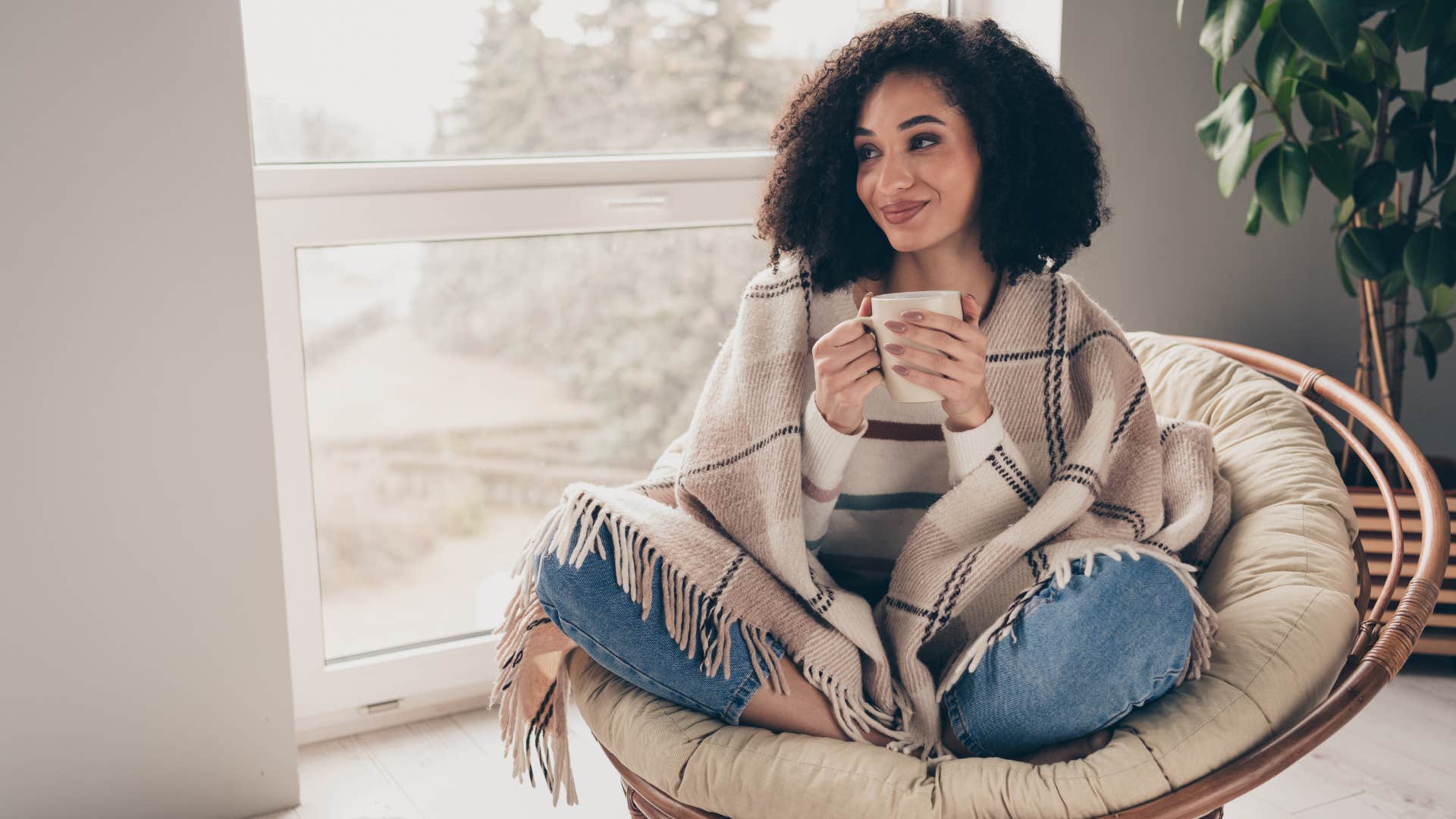 a woman is happy being alone in her home
