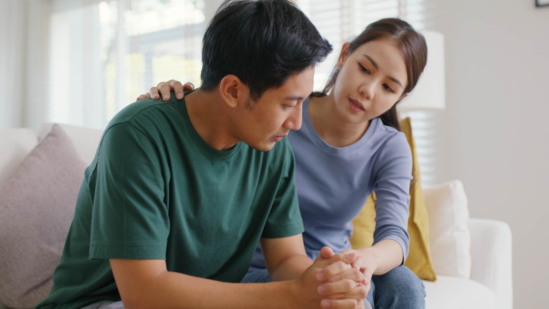 people-pleasing woman comforting her upset husband