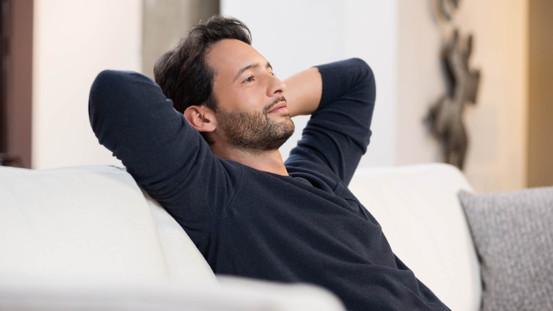 happy man daydreaming on his couch