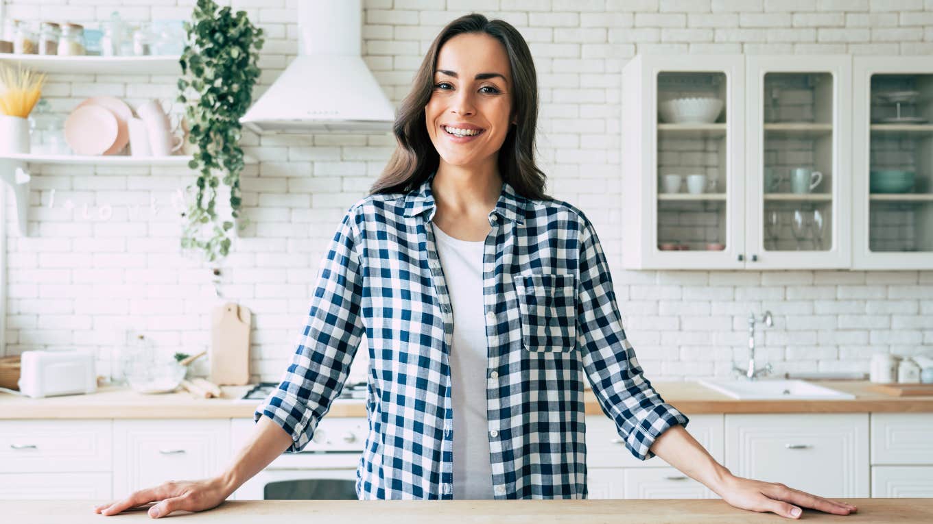 Brilliant Things Frugal Women Always Keep In Their Kitchen Cabinets happy frugal woman standing in her kitchen