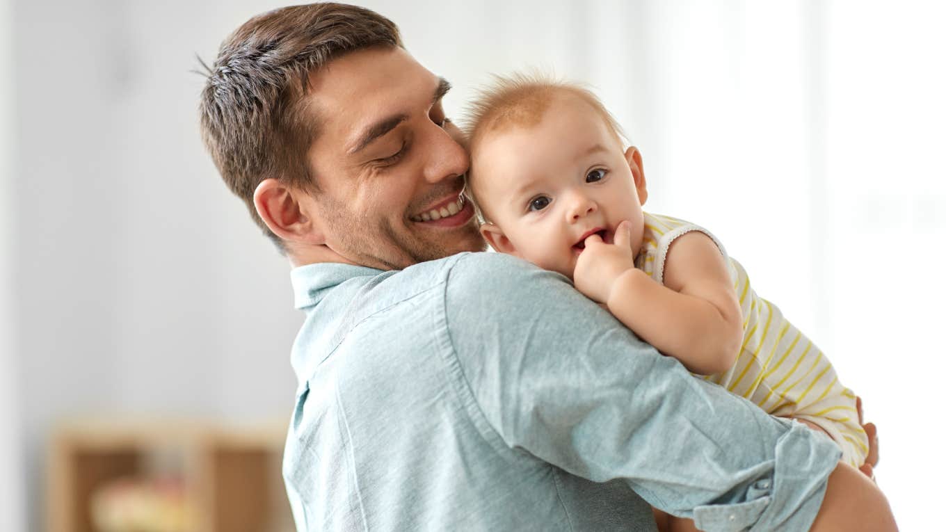 Dad Criticized For Failing The Ultimate Parenting Test dad holding baby