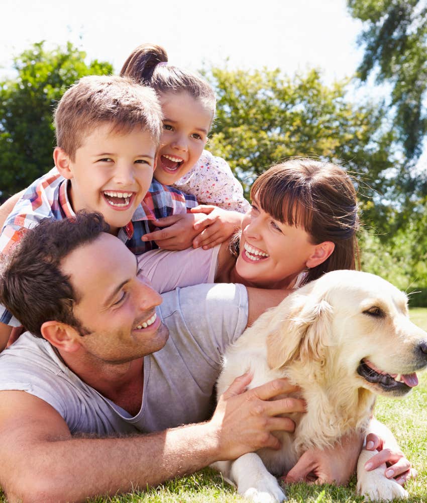 family playing with dog