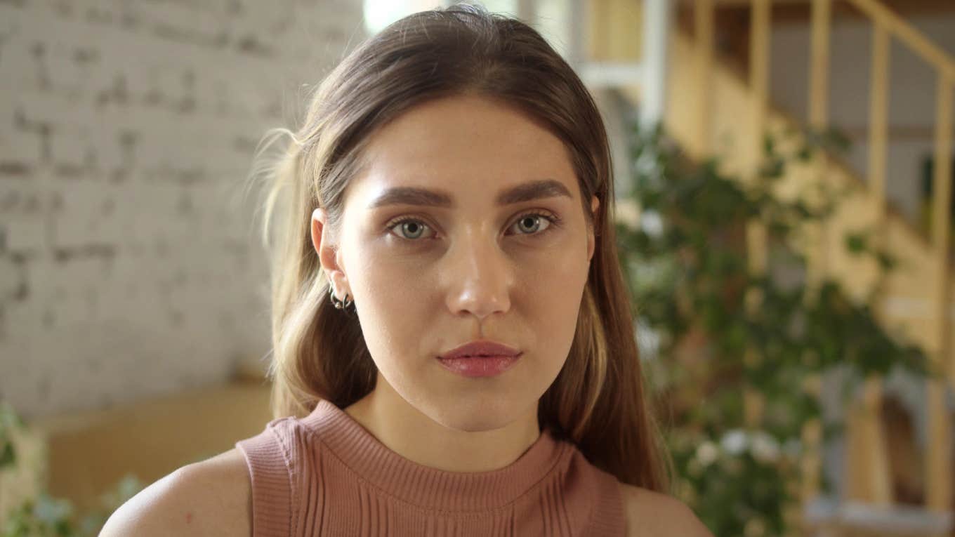 frugal woman afraid of being poor again looking sad