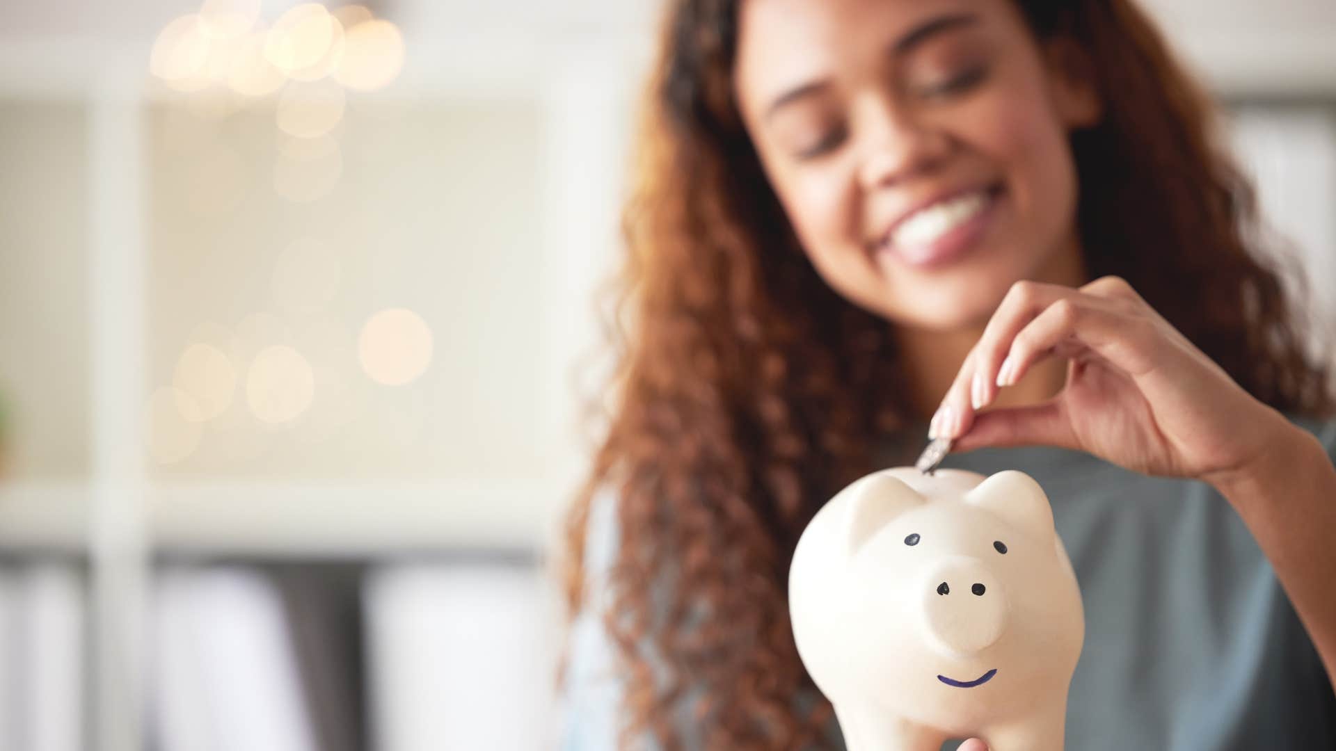 a wife saves some extra money by stashing away spare change in an old piggy bank