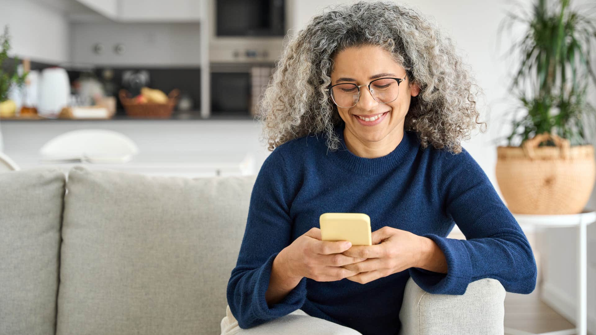 Woman adding text to their photos at home.