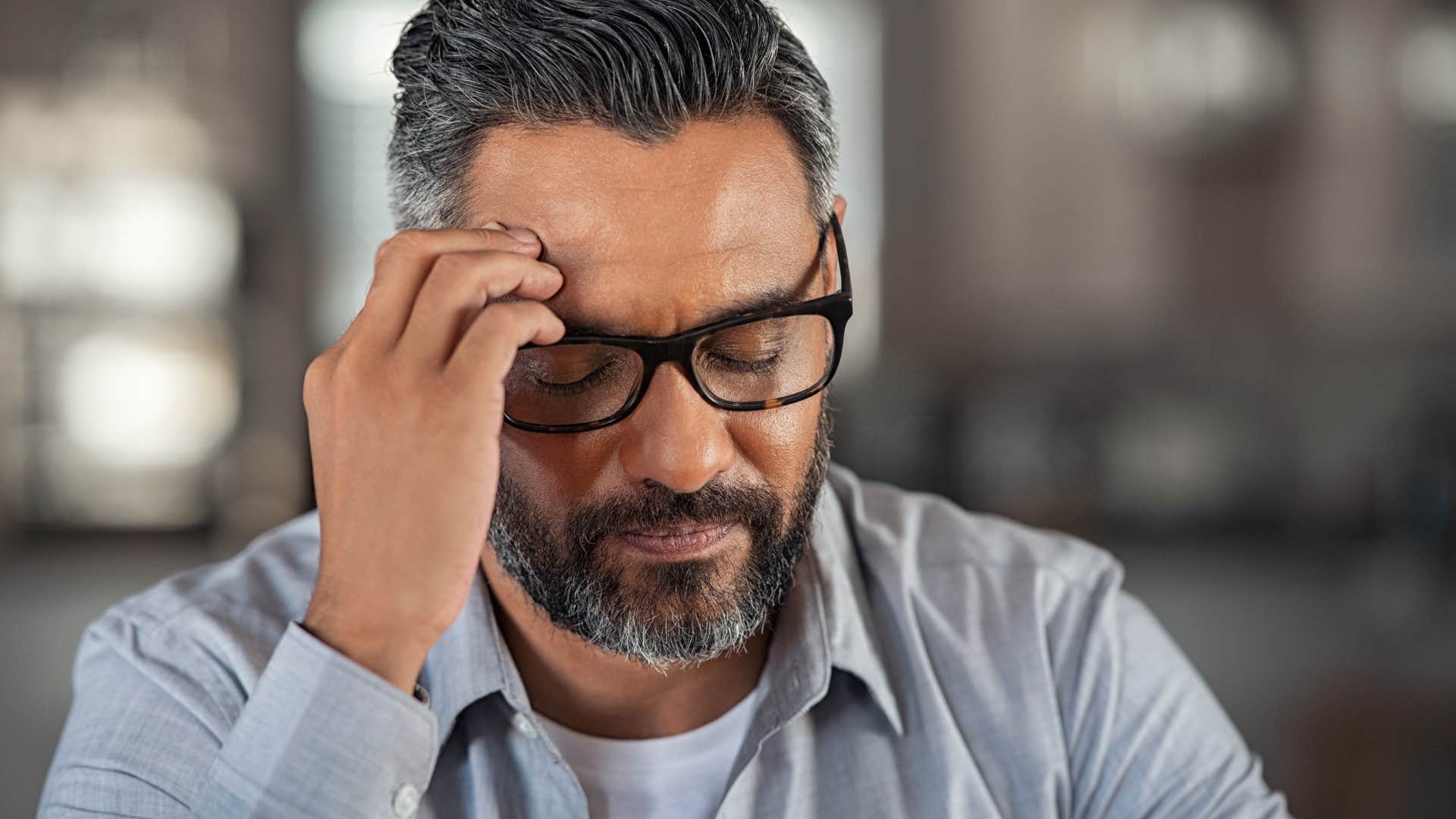 Tired man overworking for no extra compensation at the office.