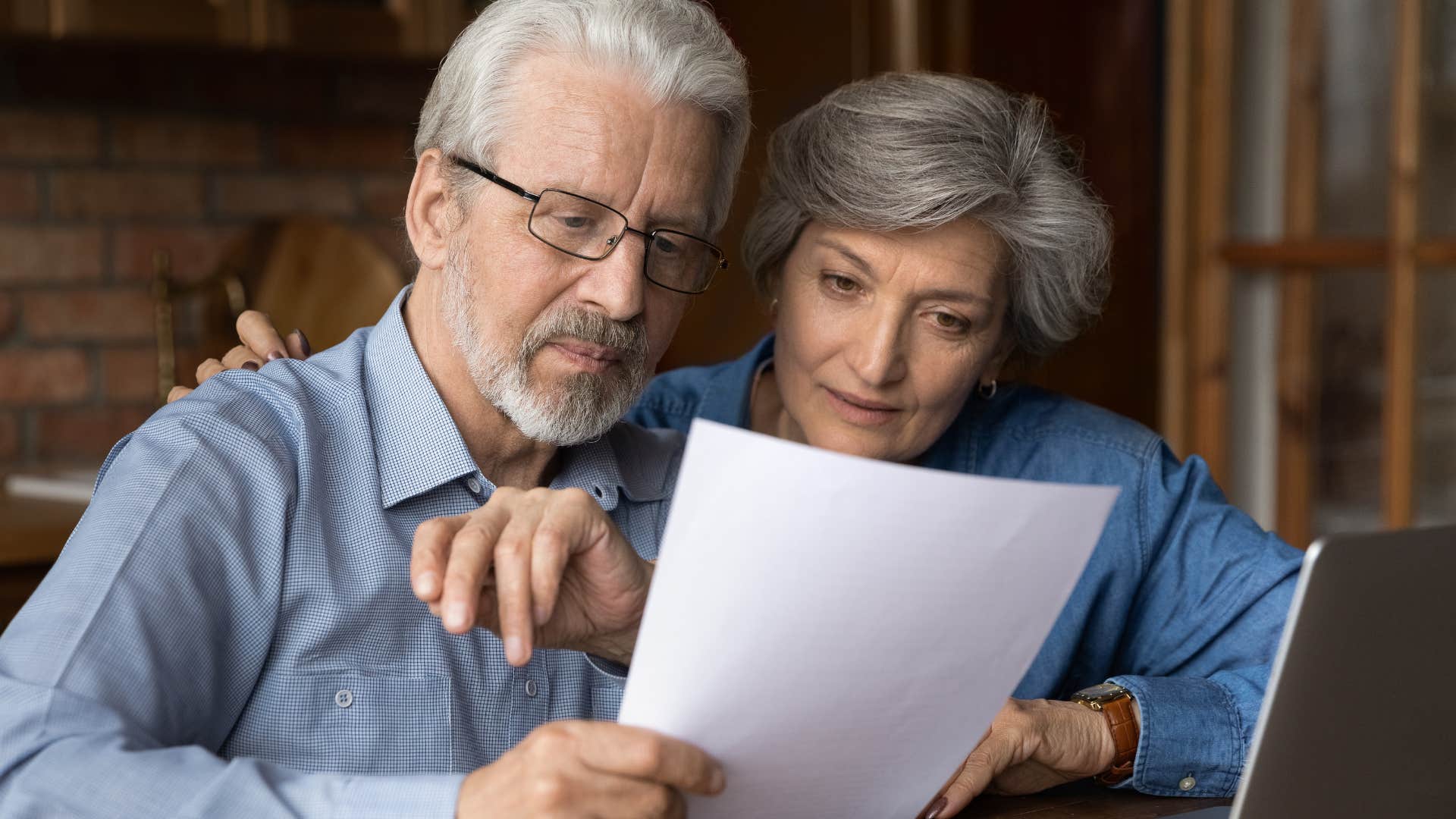 Couple printing everything out and reading a paper at home.