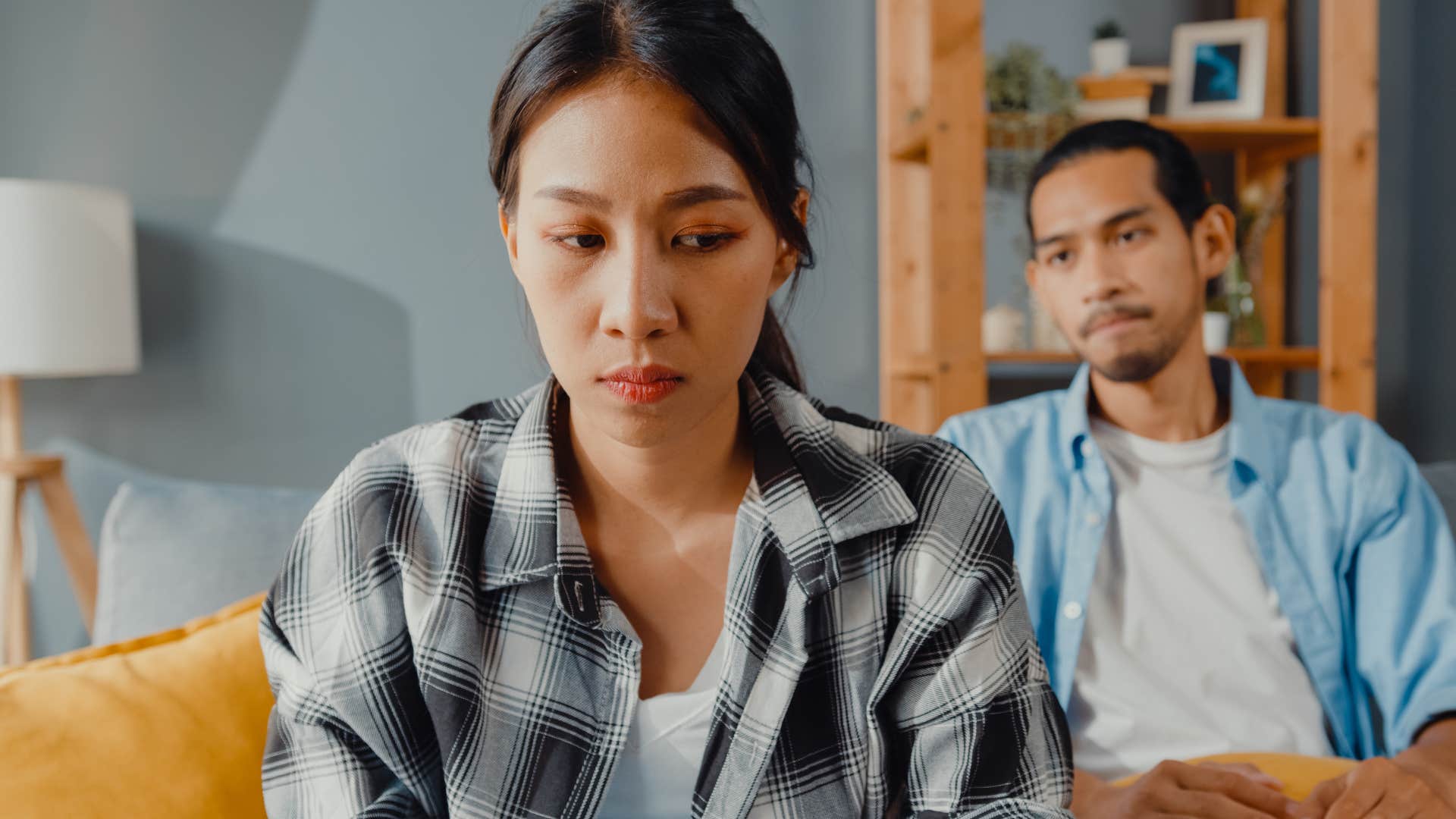 Woman acting entitled while turned away from her husband.