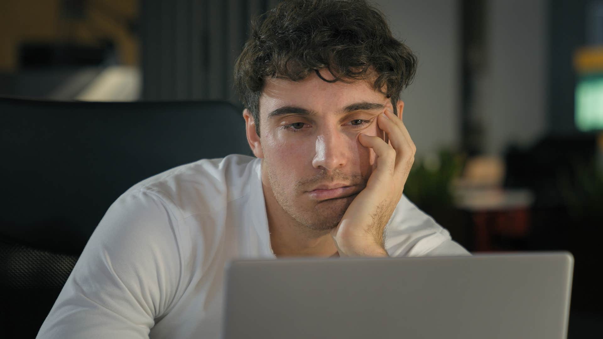 Man who's always being negative working on his laptop.