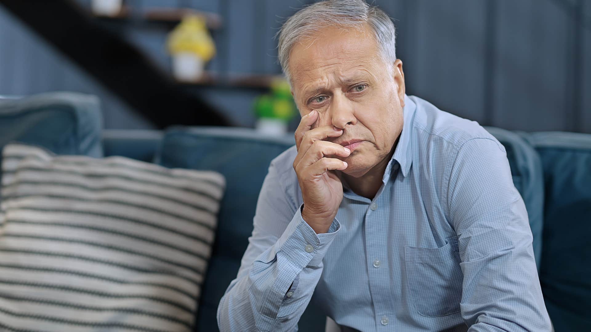 Man who's never asking for help sitting at home alone.