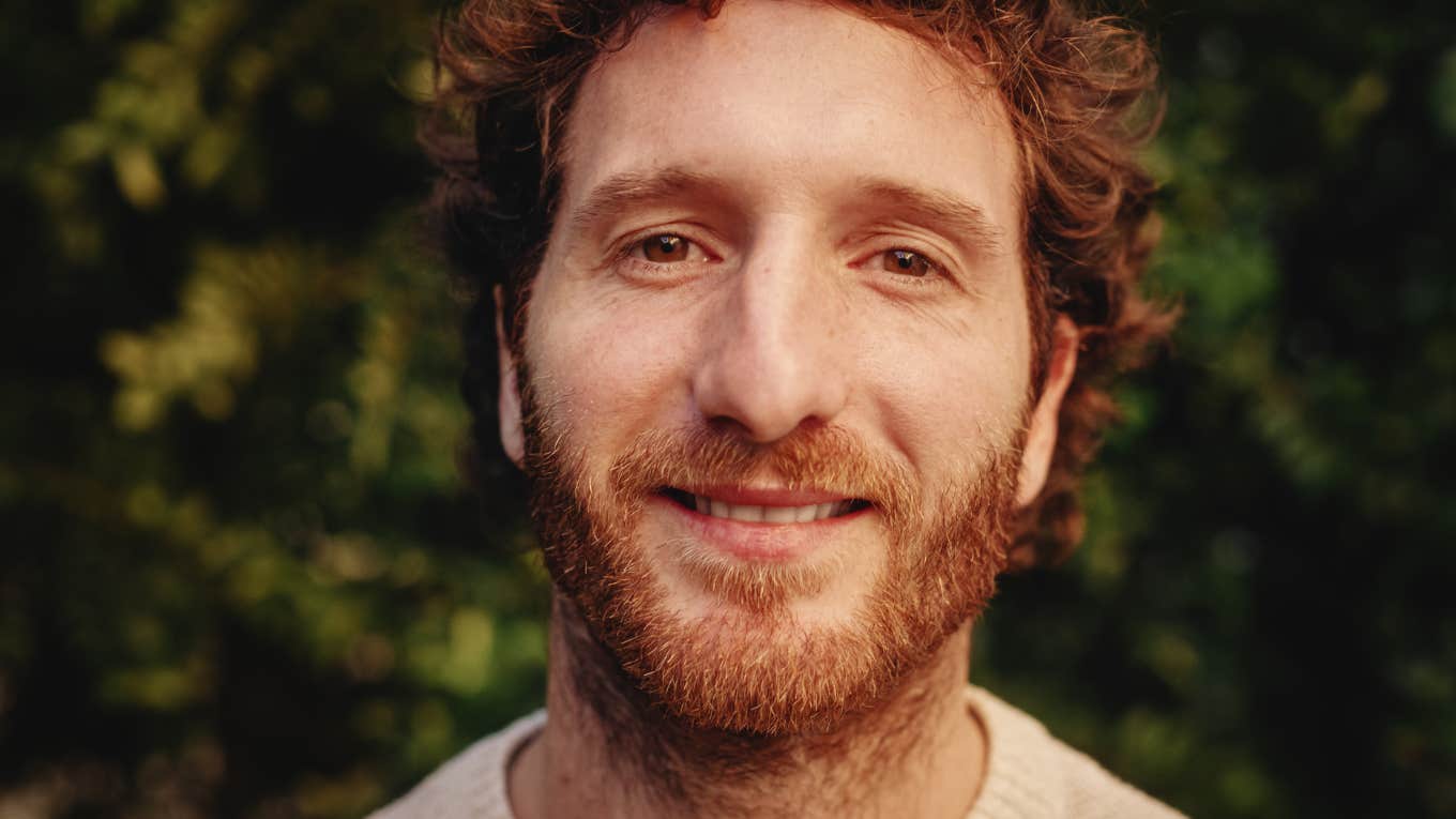 smiling man not letting on his intelligence level
