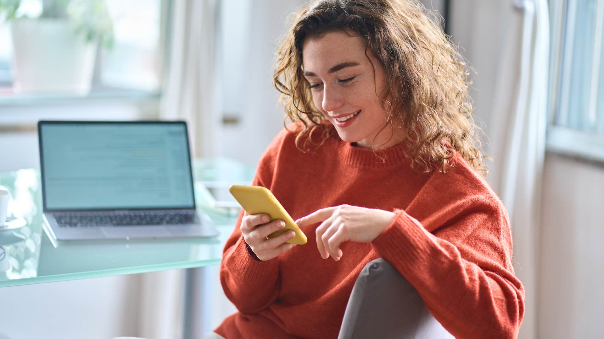 woman looking at phone avoiding books