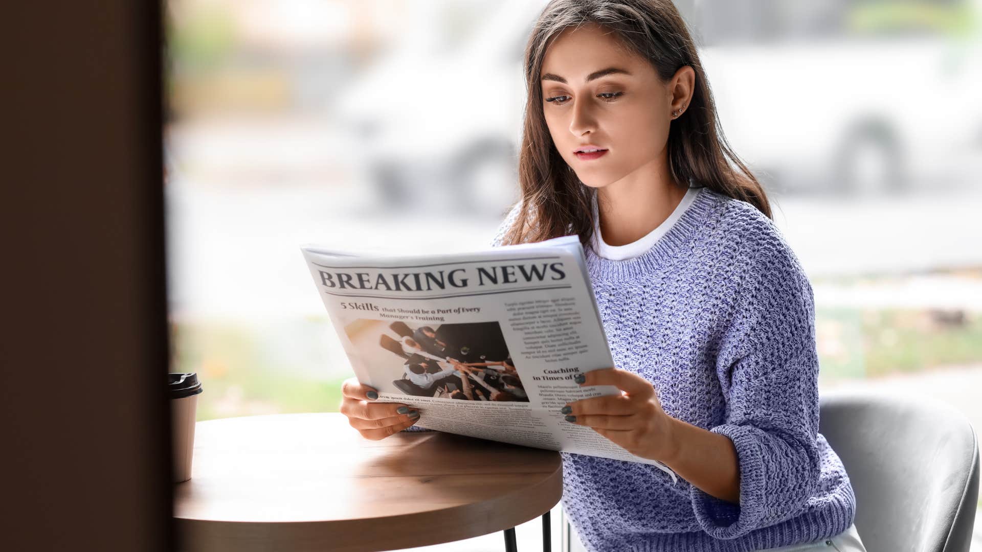 woman reading headlines in newspaper