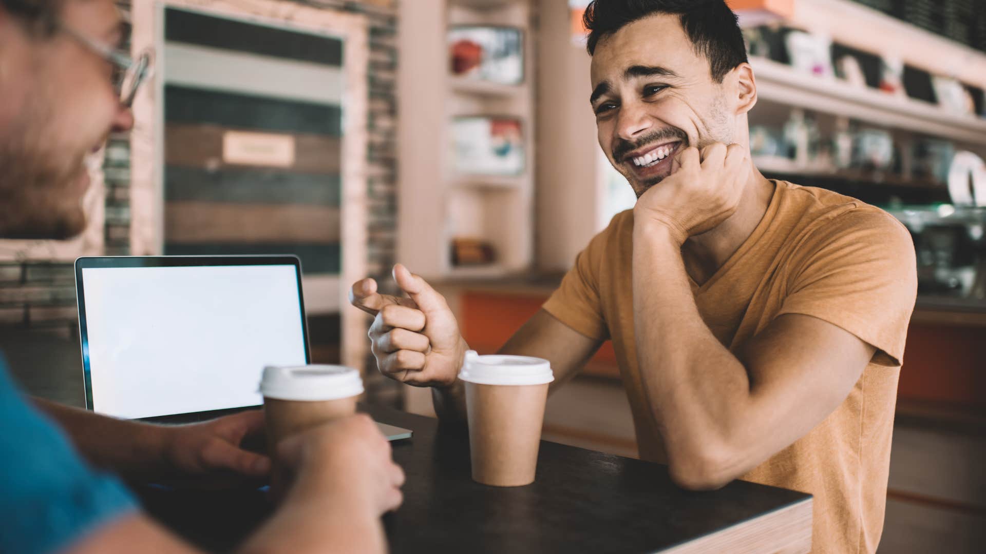 unintelligent man laughing during serious conversation