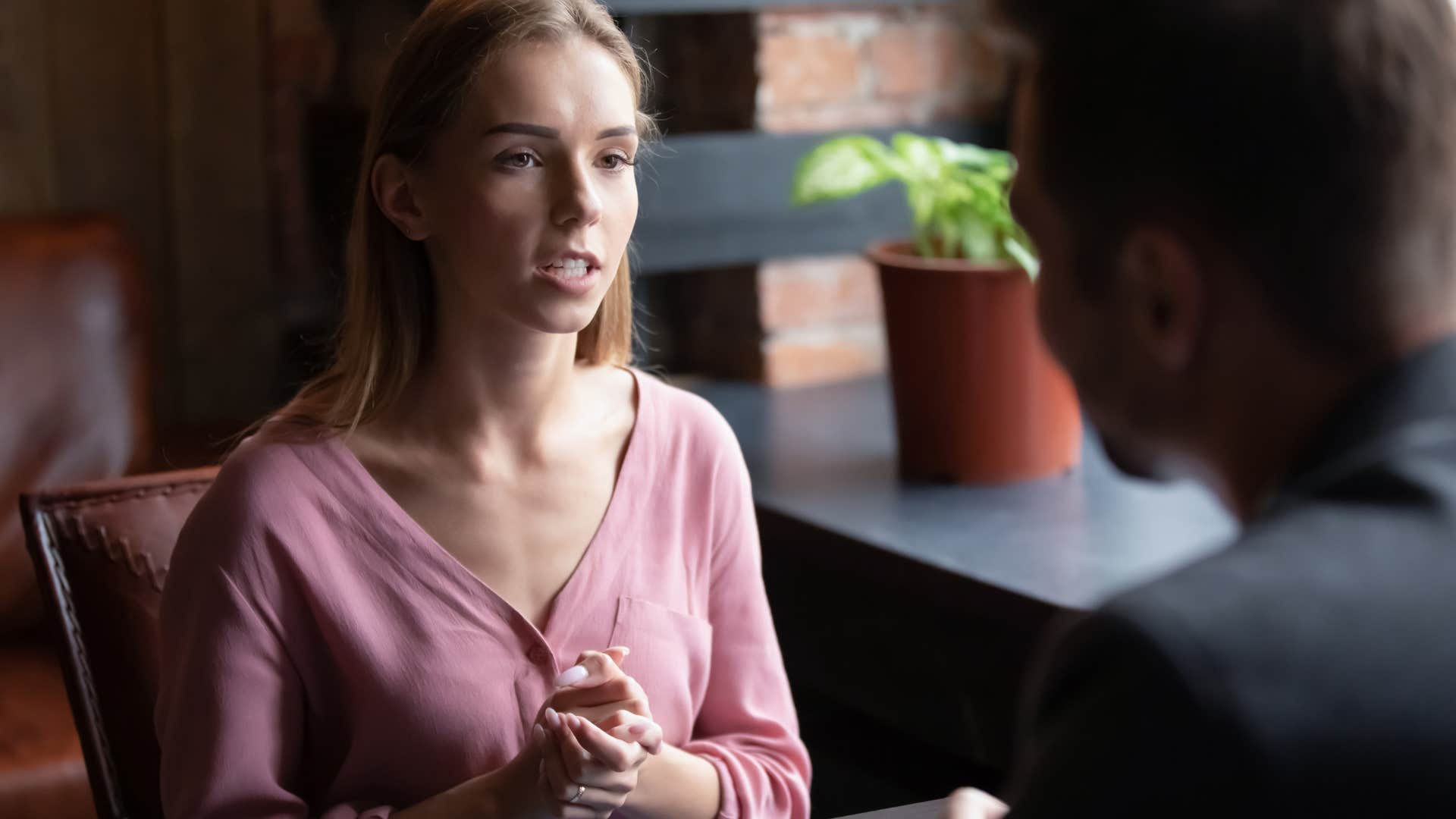 serious woman talking to someone behind desk