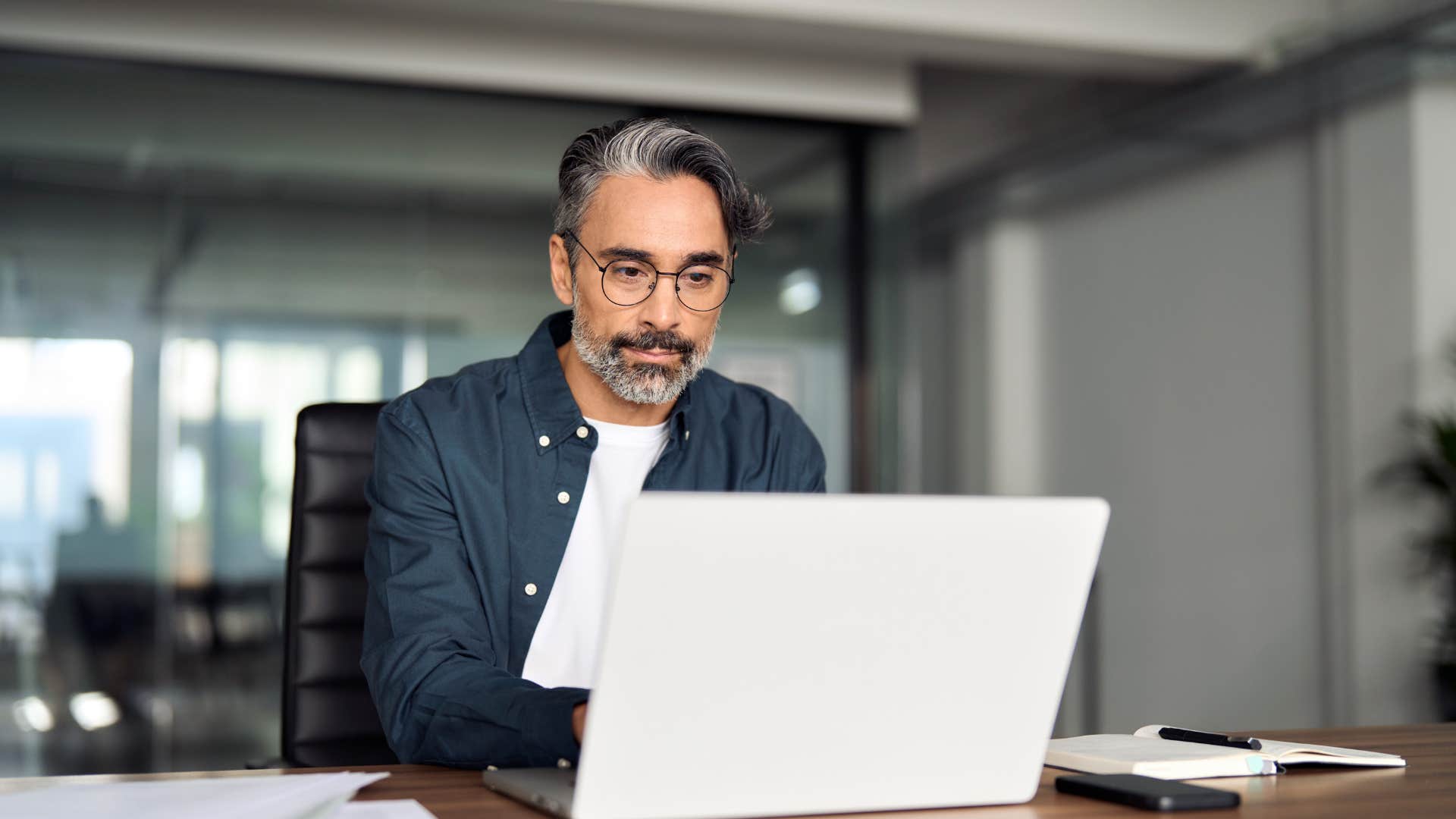 man working at his desk trying to be productive