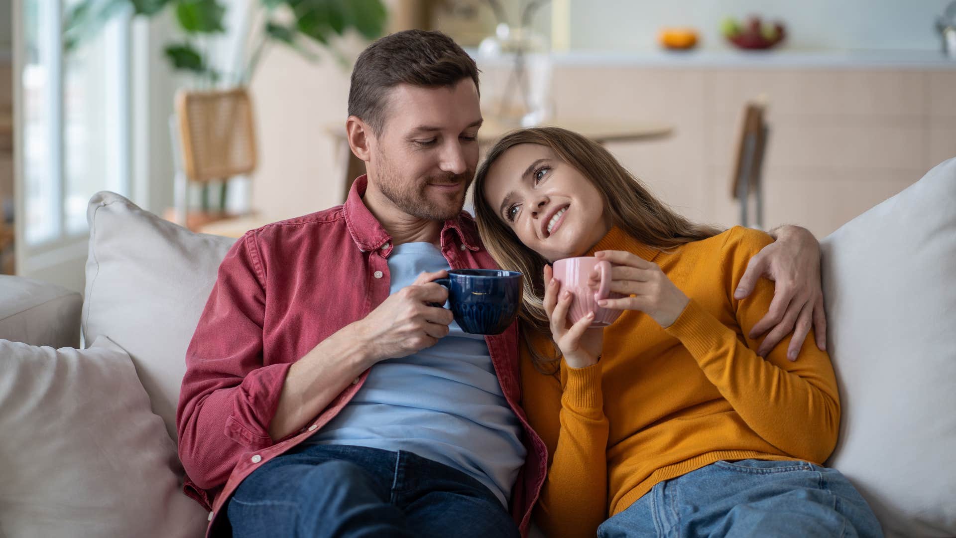 wife feeling love from husband on couch