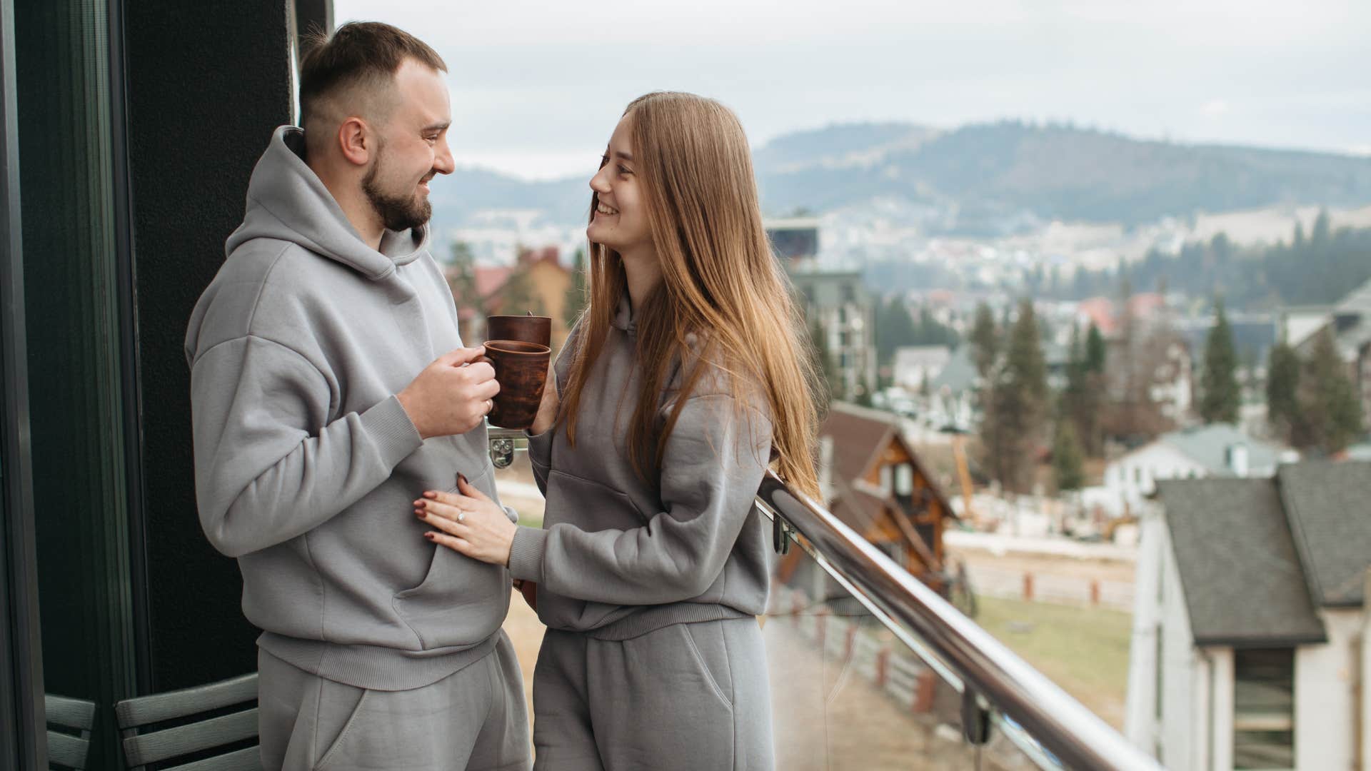 couple dressed in gray using matching mugs