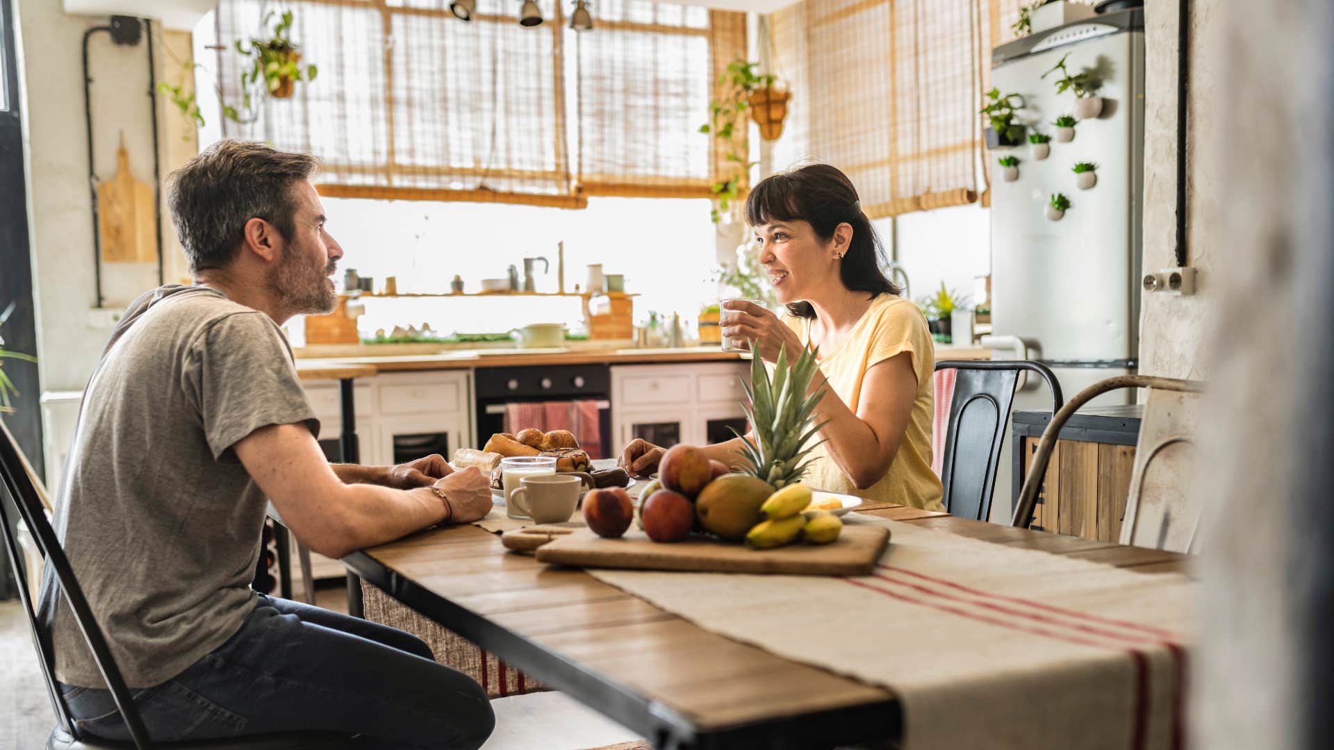 couple eating together on a well used dining table