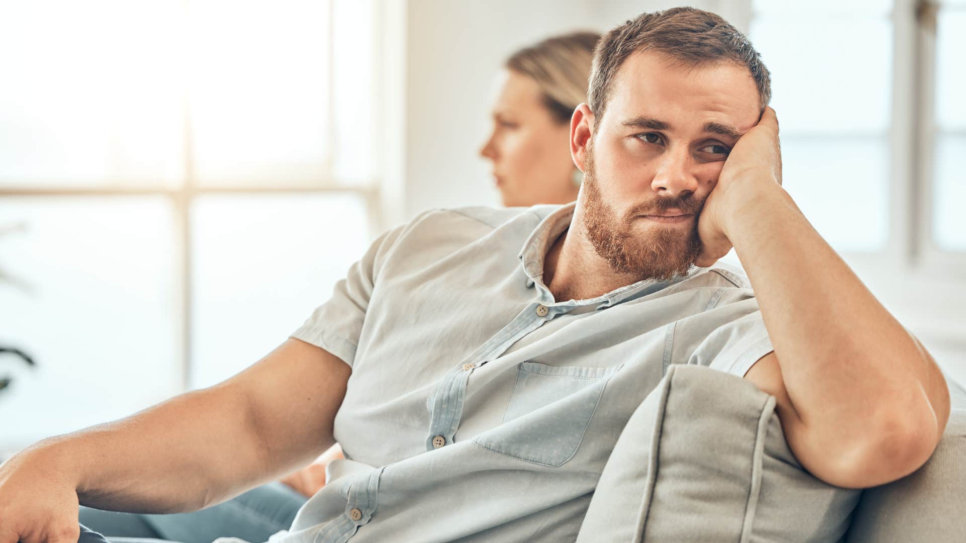 man getting annoyed about little things turned away from his wife