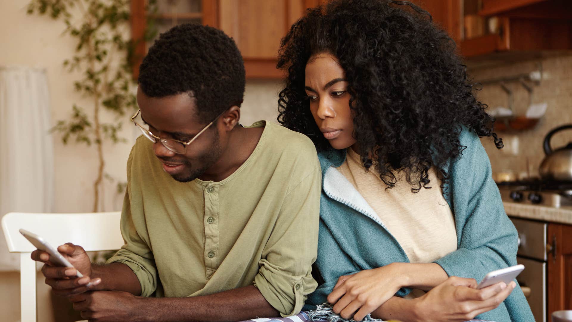 man distracting himself with other relationships looking at his phone