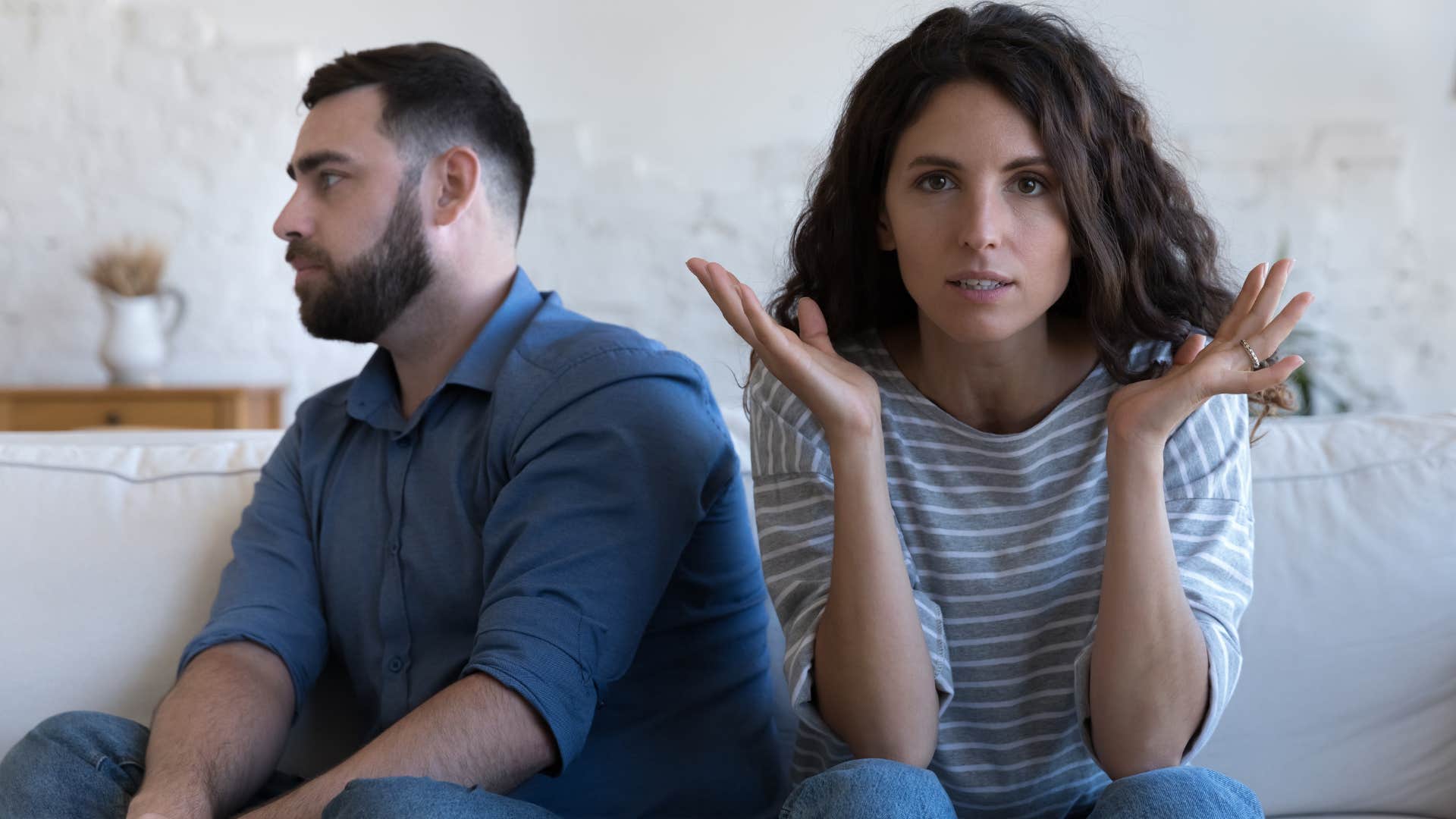 man who doesn't argue sitting next to his upset wife