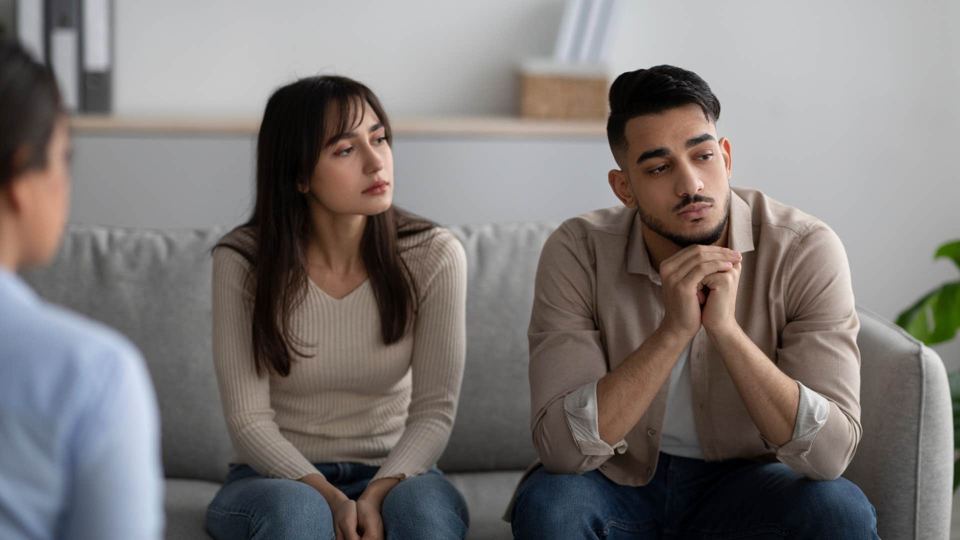 couple staying quiet in presence of a guest