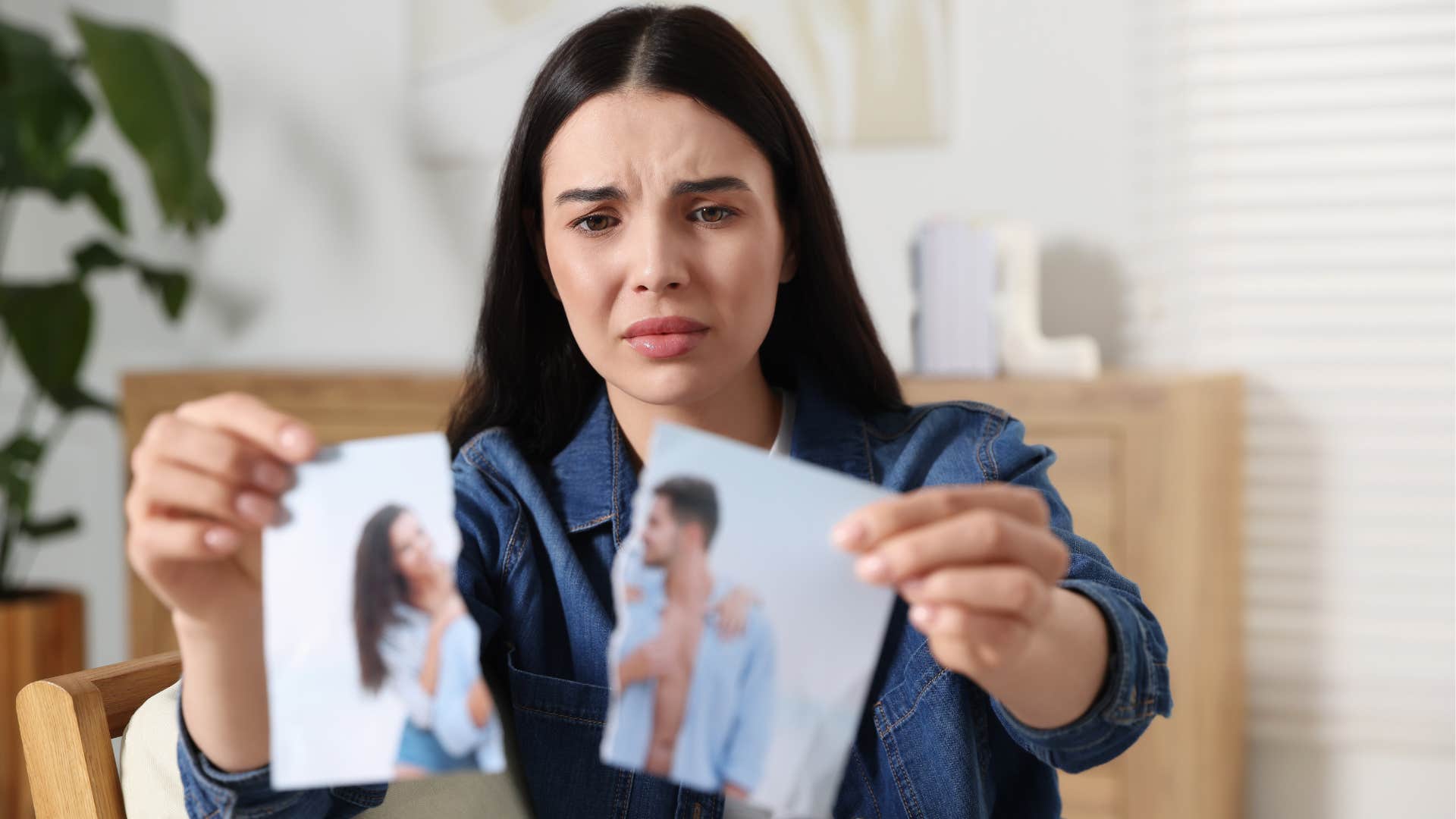 woman ripping up photo of her and her partner