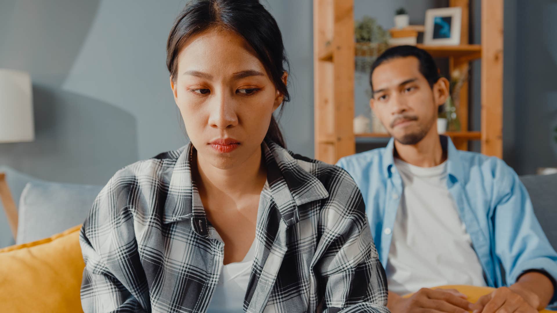 Woman turned away from her partner who stops saying "I love you."