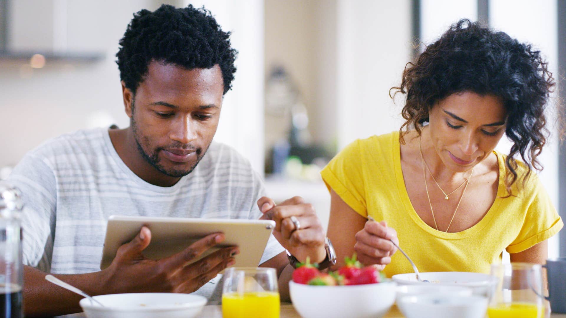 woman sitting next to husband uninterested in her day