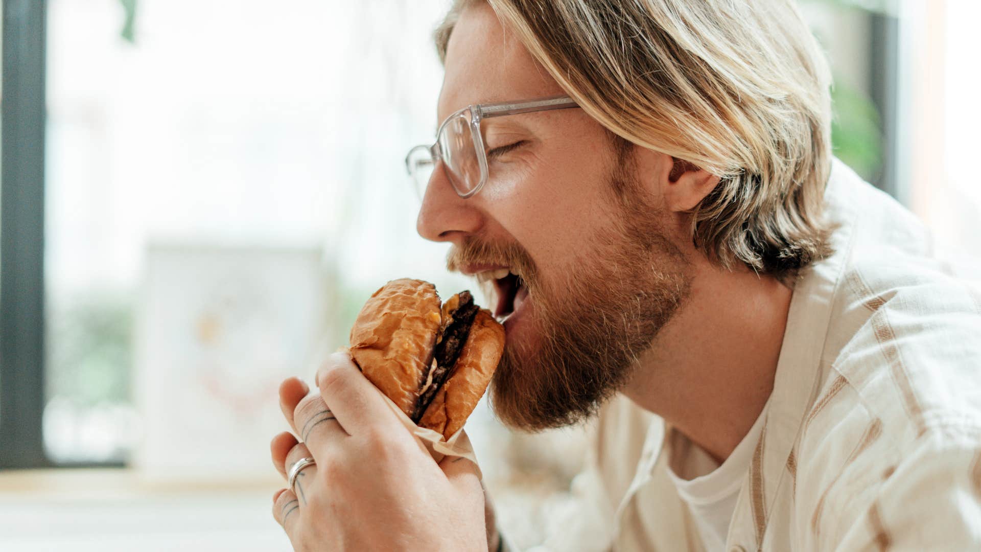 man rushing through eating his food